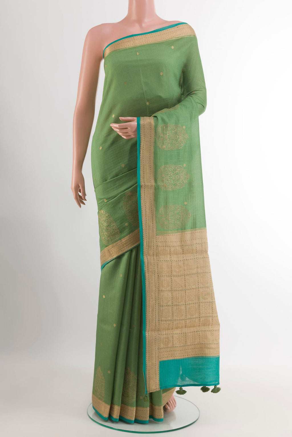 Green Tussar Saree with Zari Butta on the body and Zari Border.  displayed on a mannequin