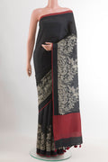 Black Tussar Saree with Printed design on the body and Thread Embroidery Border.  displayed on a mannequin