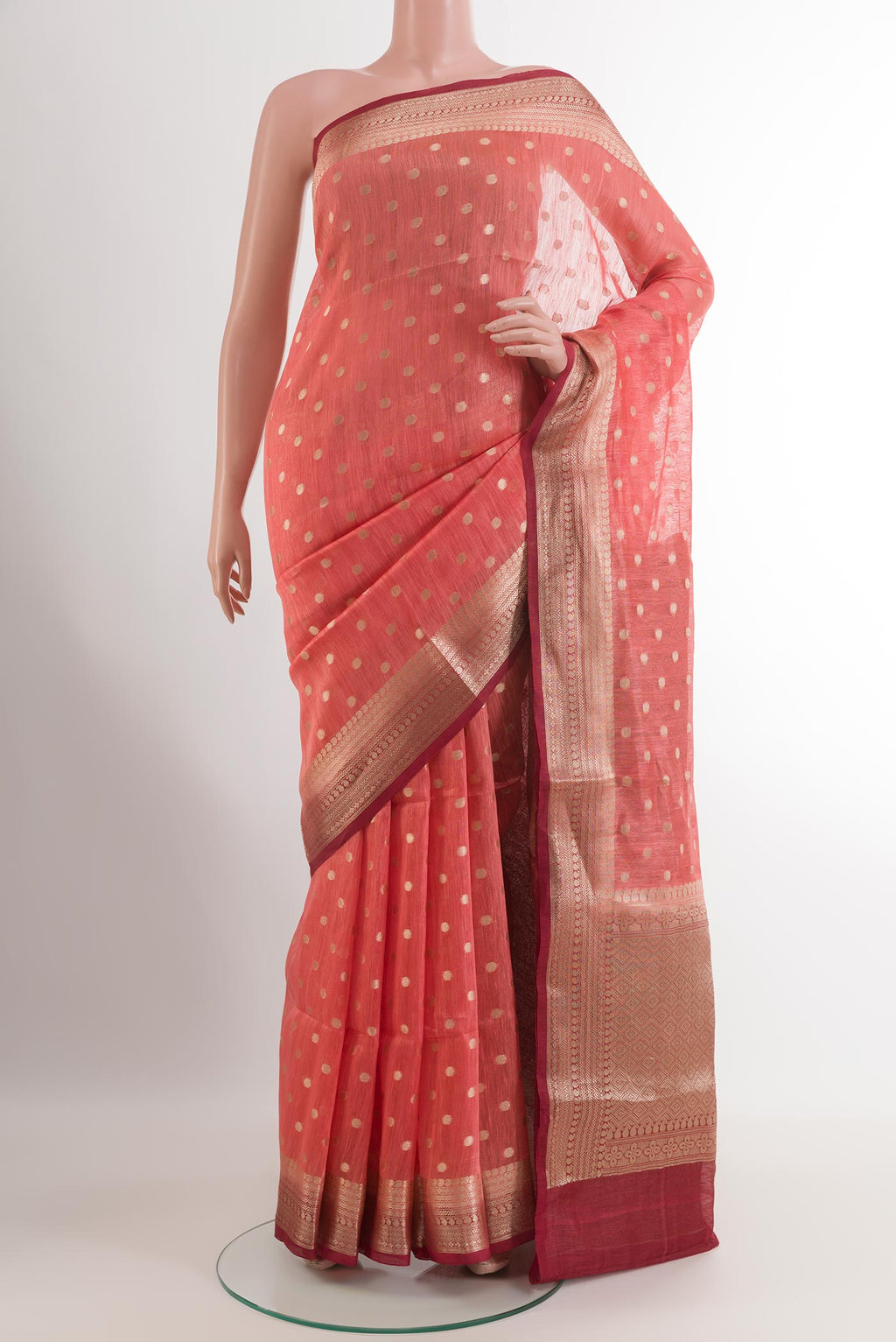 Pink Linen Saree with Zari Butta on the body and Zari Border.  displayed on a mannequin