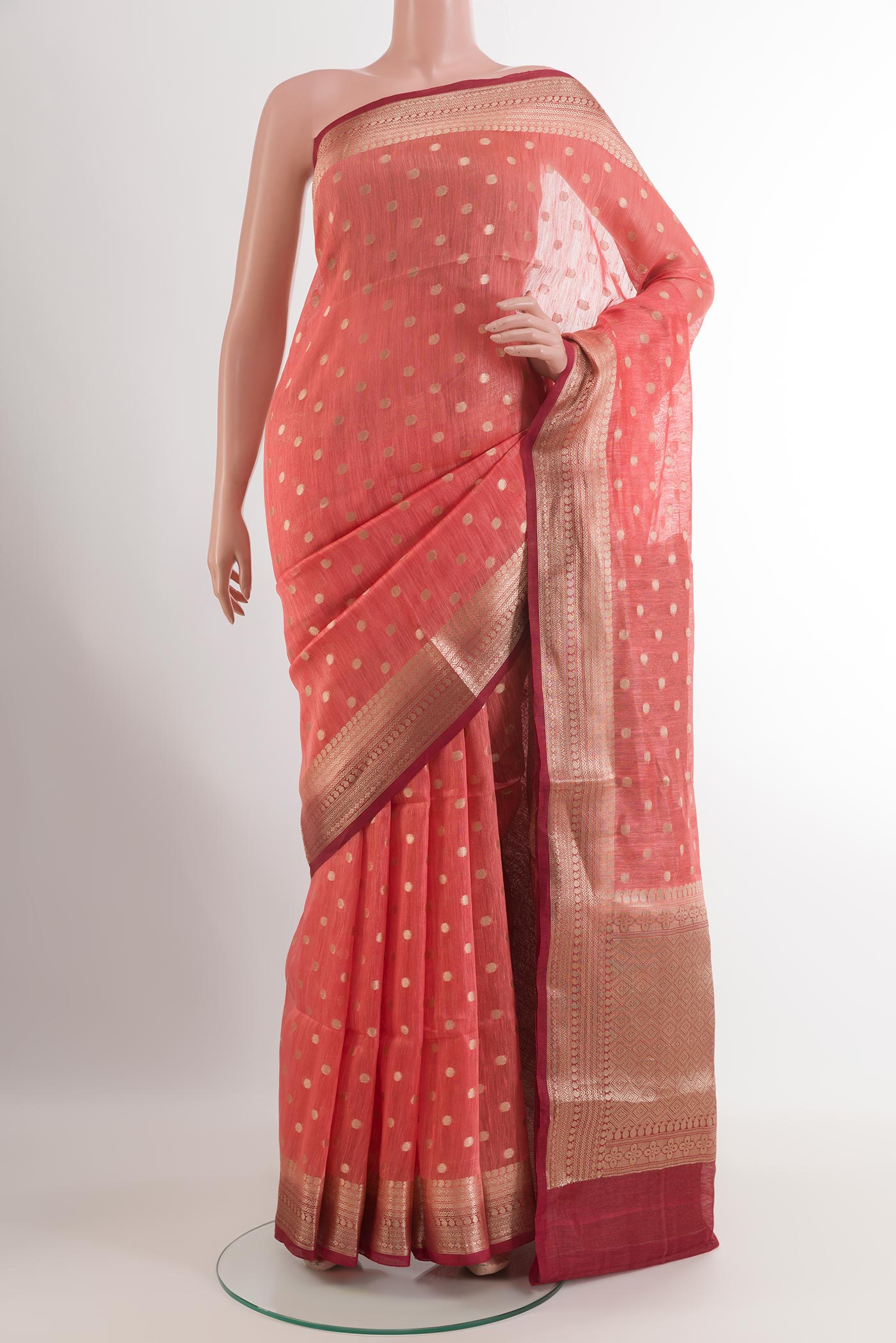 Pink Linen Saree with Zari Butta on the body and Zari Border.  displayed on a mannequin