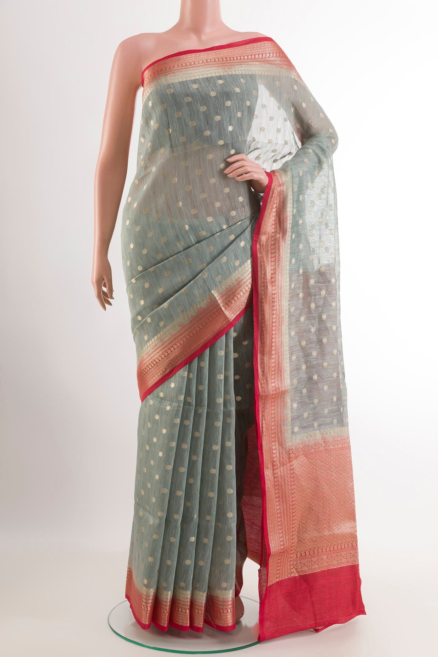 Grey Linen Saree with Zari Butta on the body and Zari Border.  displayed on a mannequin
