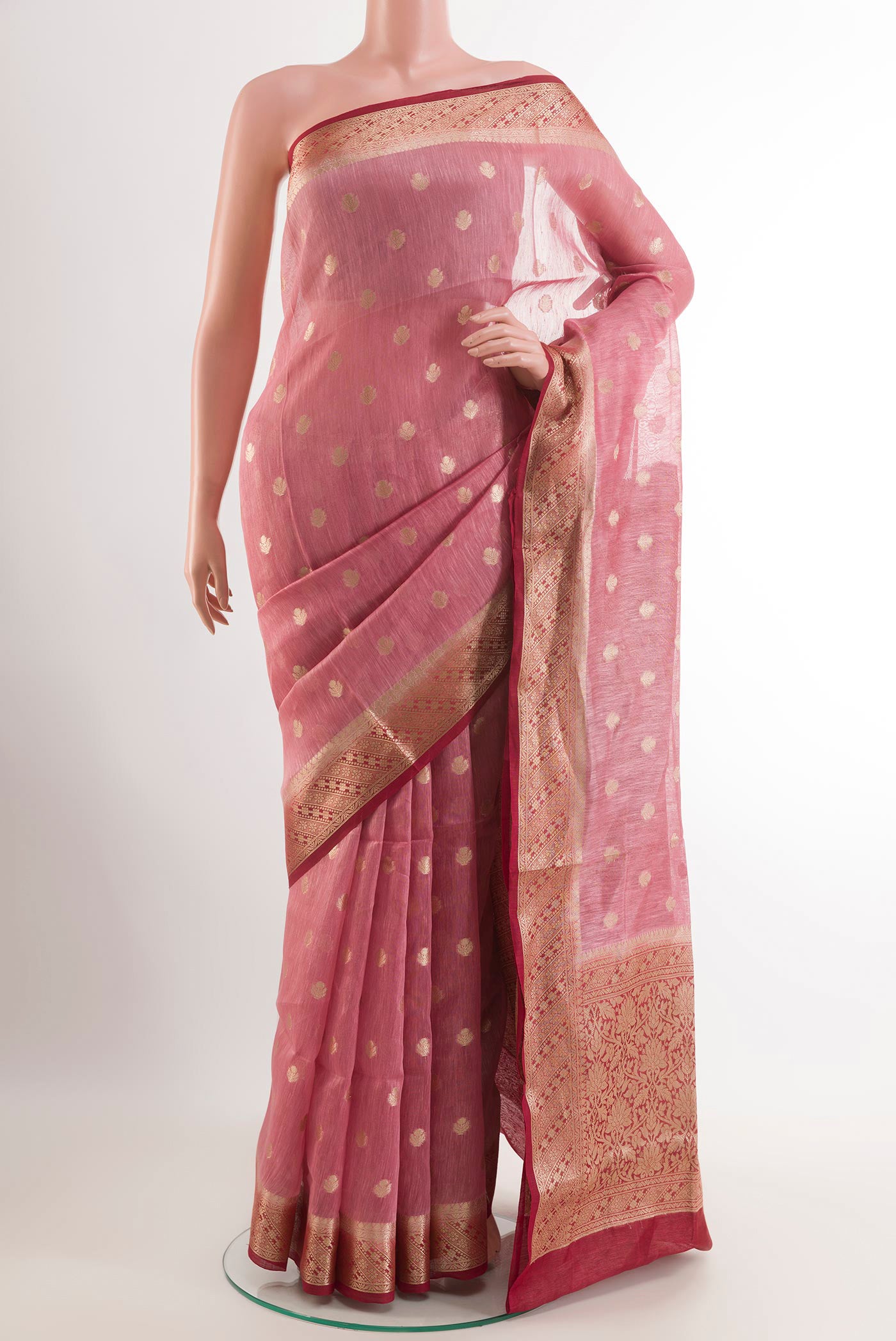 Pink Linen Saree with Zari Butta on the body and Zari Border.  displayed on a mannequin