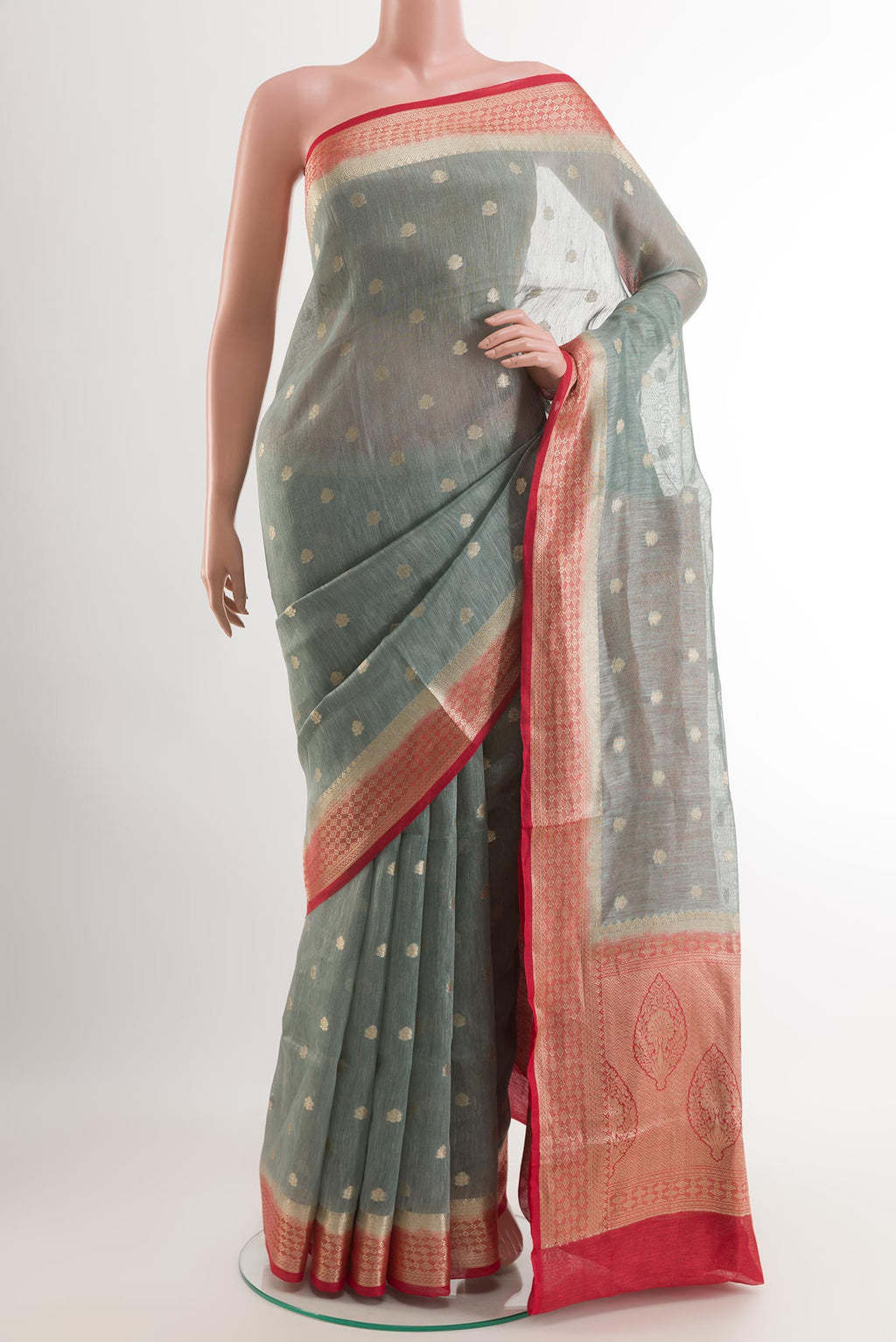 Grey Linen Saree with Zari Butta on the body and Zari Border.  displayed on a mannequin