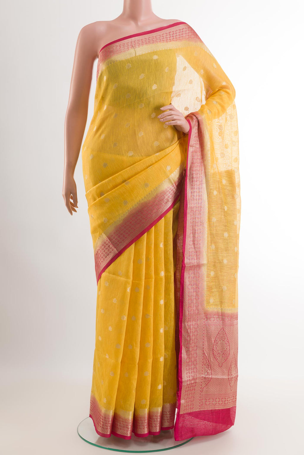 Yellow Linen Saree with Zari Butta on the body and Zari Border.  displayed on a mannequin
