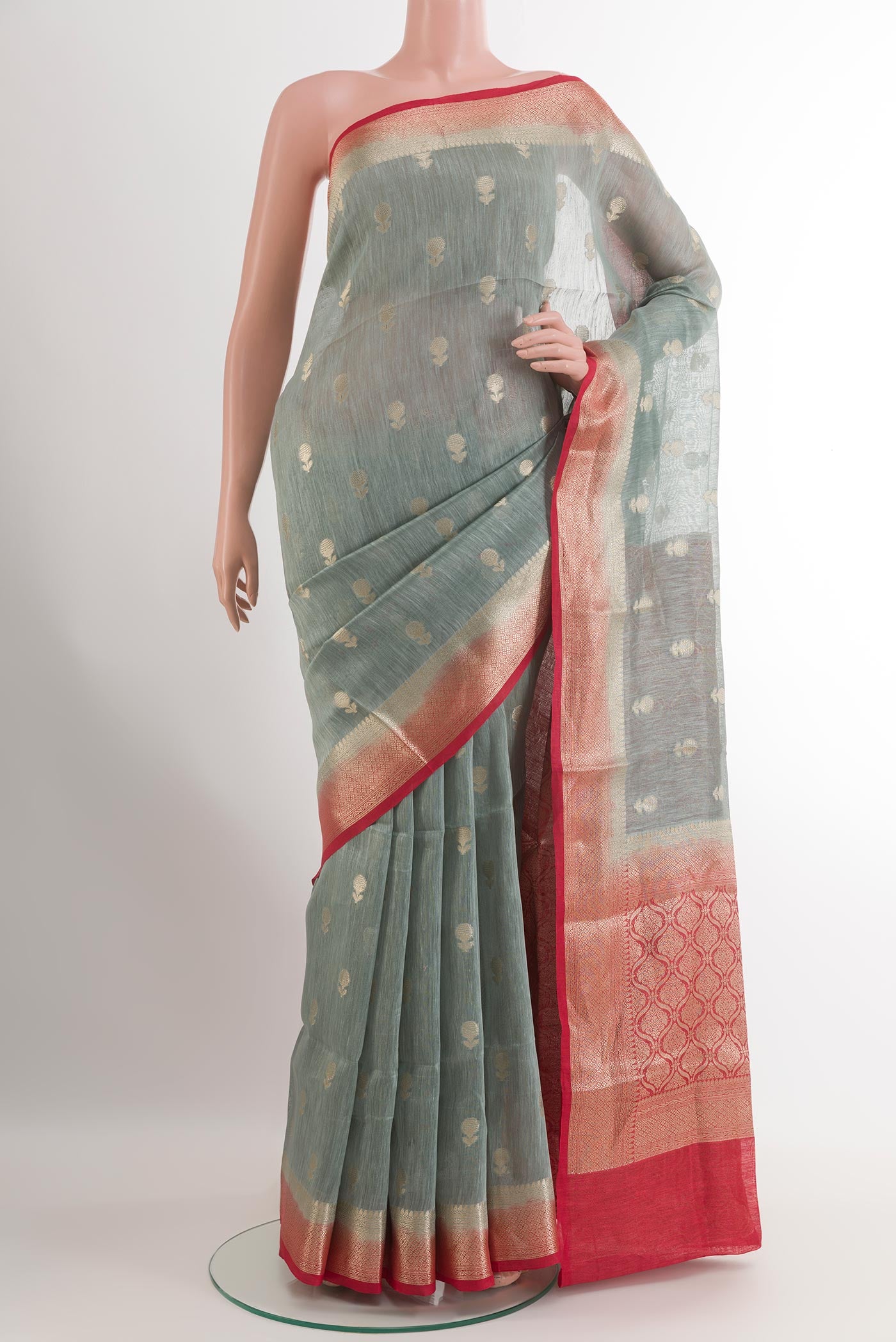 Grey Linen Saree with Zari Butta on the body and Zari Border.  displayed on a mannequin