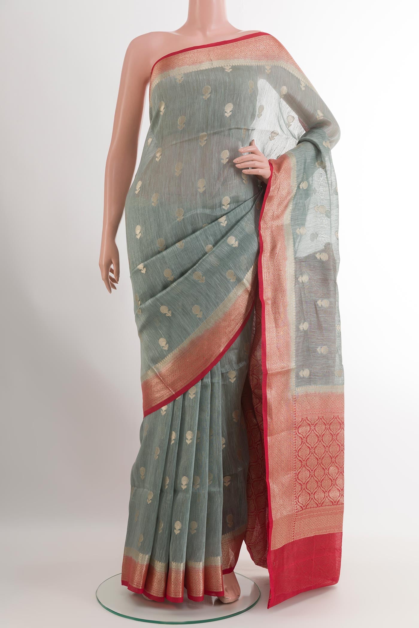 Grey Linen Saree with Zari Butta on the body and Zari Border.  displayed on a mannequin