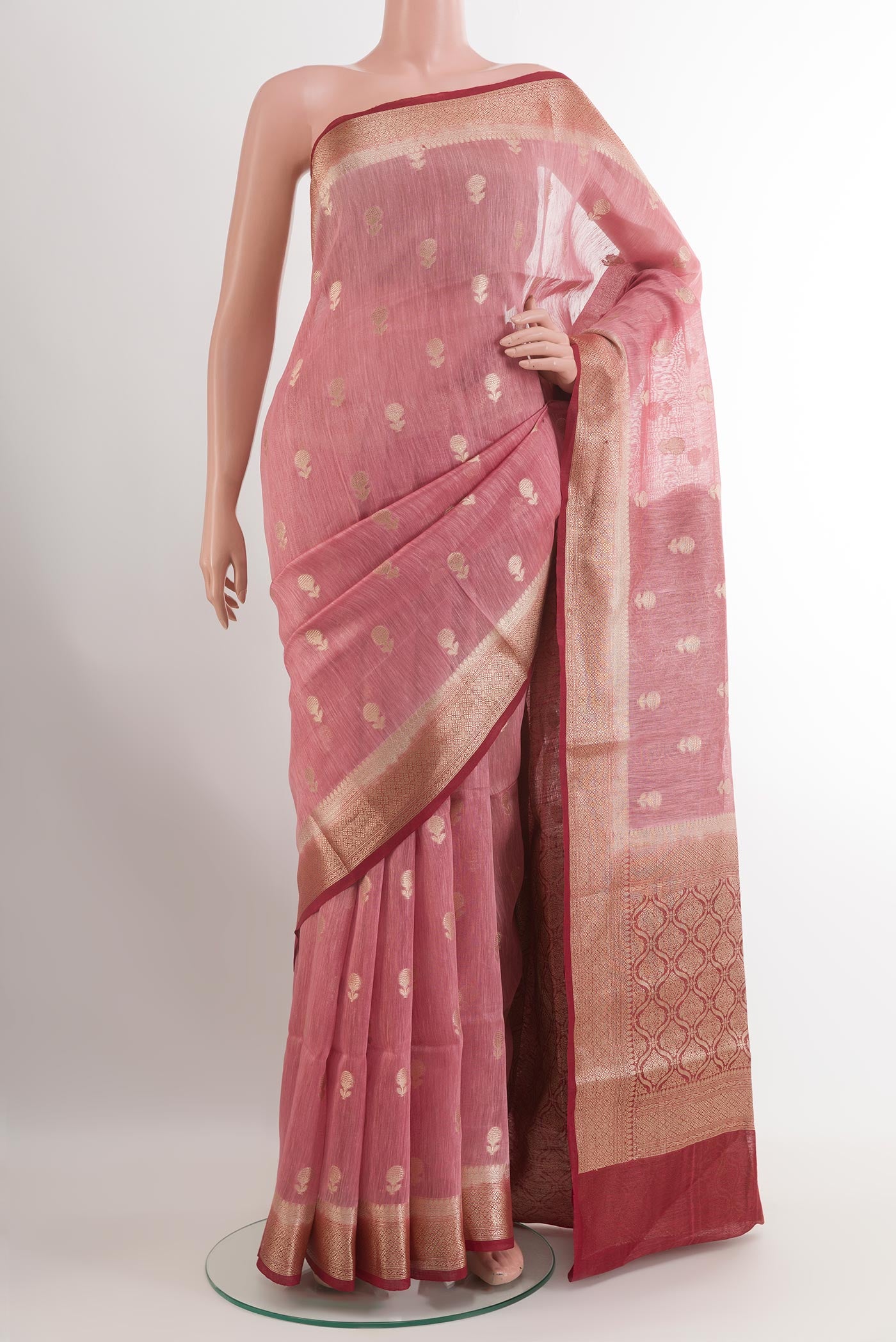 Pink Linen Saree with Zari Butta on the body and Zari Border.  displayed on a mannequin