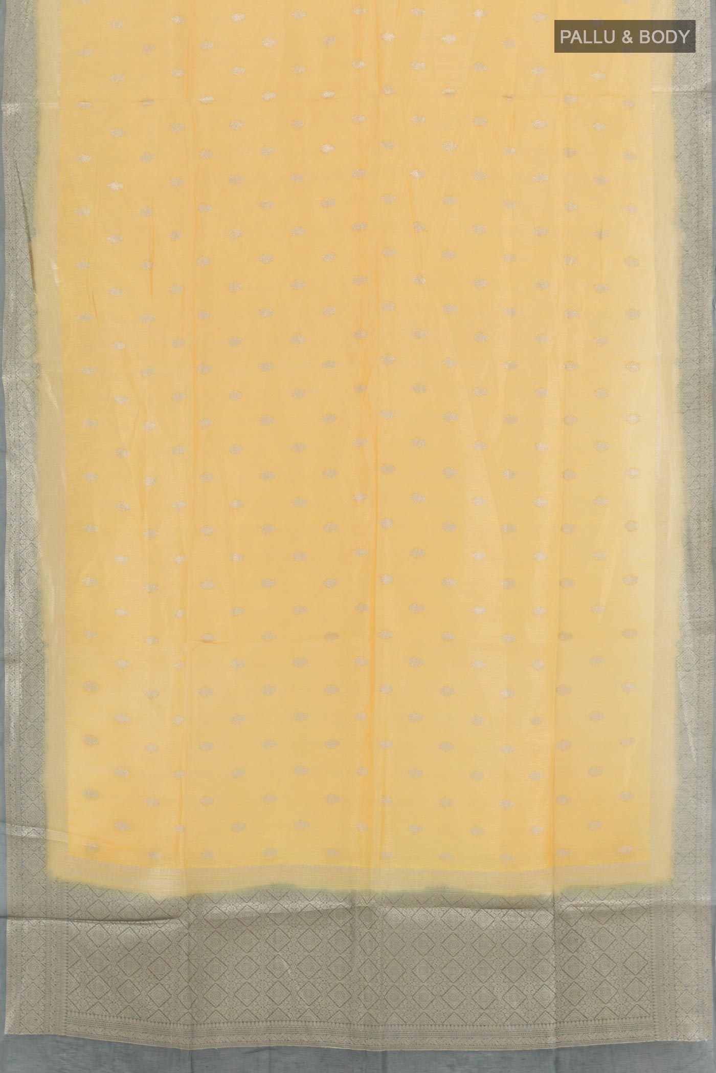 Flat view of Yellow Linen Saree with Zari Butta on the body and Zari Border. 