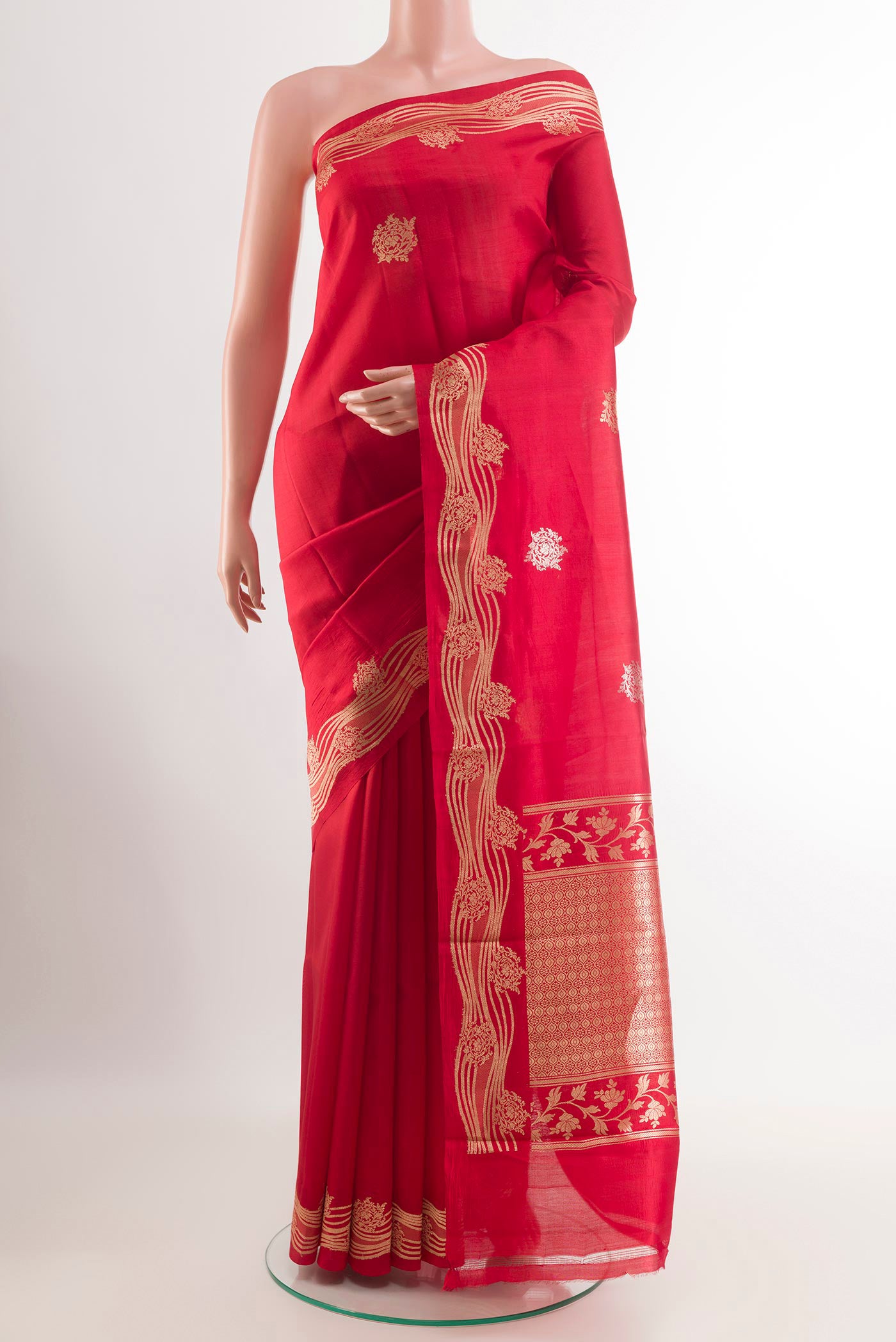Red Tussar Silk Saree with Zari Butta on the body and Zari Border.  displayed on a mannequin
