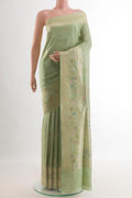 Pista Green Banarasi Tussar Silk Saree with Zari Butta on the body and Zari Border.  displayed on a mannequin