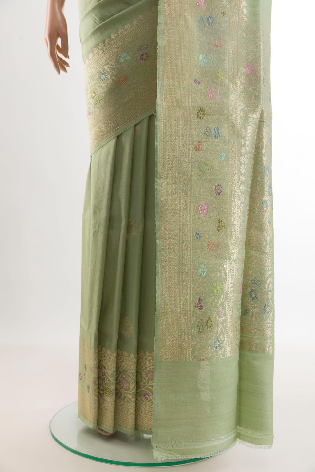 Pleats and pallu of Pista Green Banarasi Tussar Silk Saree with Zari Butta on the body and Zari Border. 