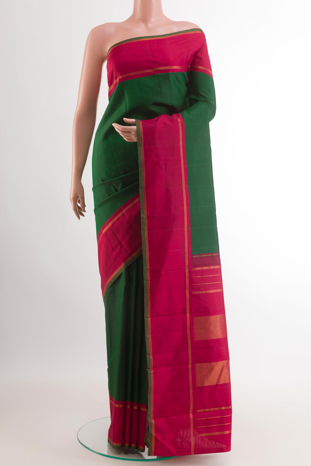 Green Kanchipuram Silk Saree with Plain Body and Zari Border.  displayed on a mannequin