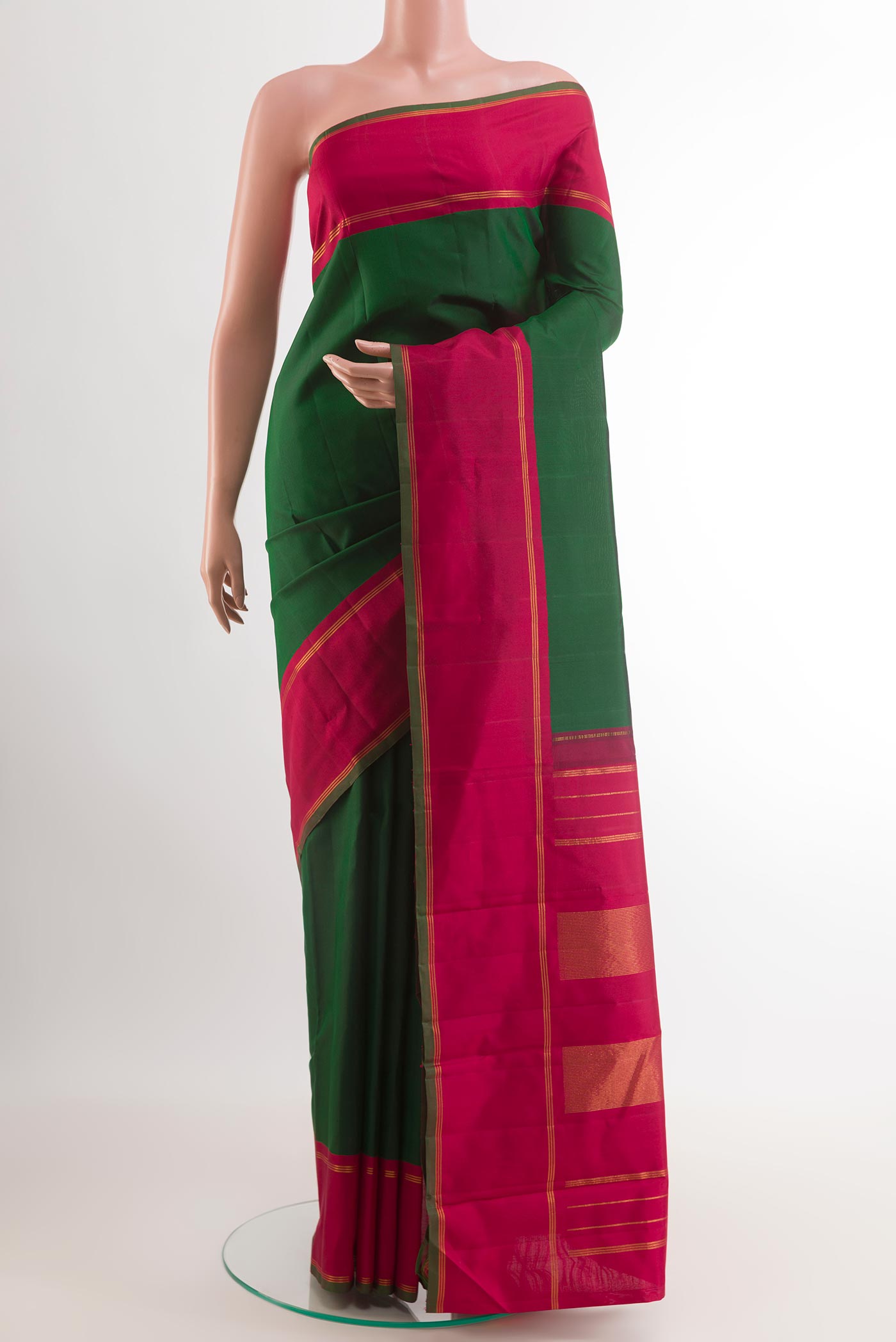 Green Kanchipuram Silk Saree with Plain Body and Zari Border.  displayed on a mannequin