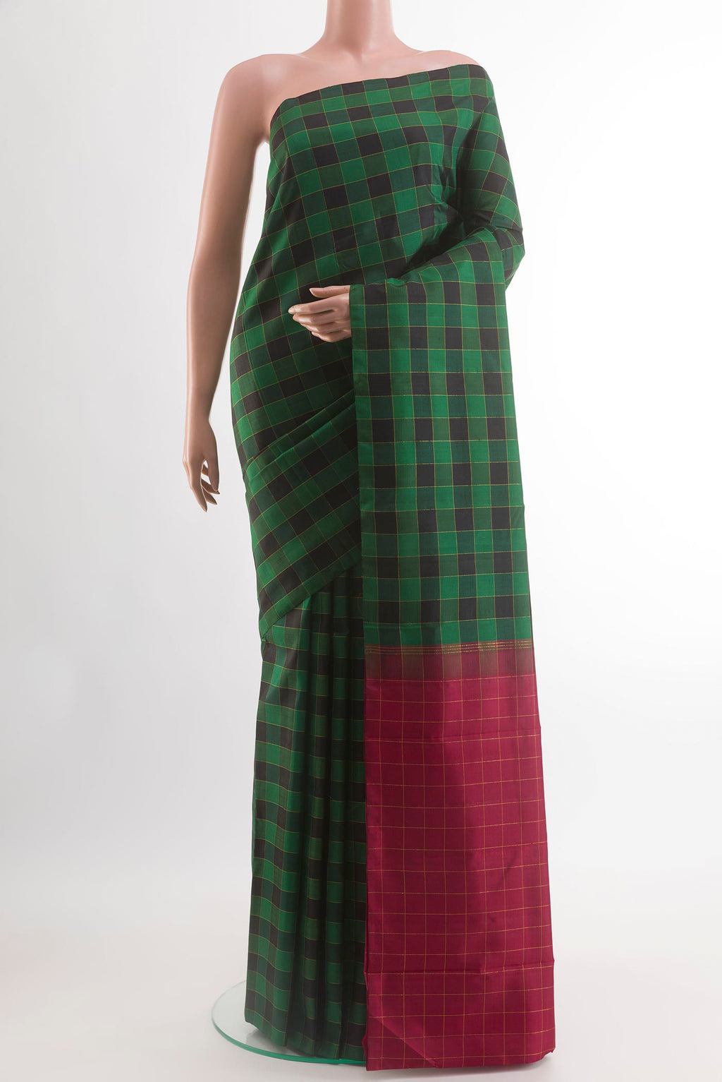 Green Kanchipuram Silk Saree with Checked design on the body and Zari Border.  displayed on a mannequin