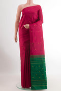 Maroon Kanchipuram Silk Saree with Zari Butta on the body and Ganga Jamuna Border.  displayed on a mannequin