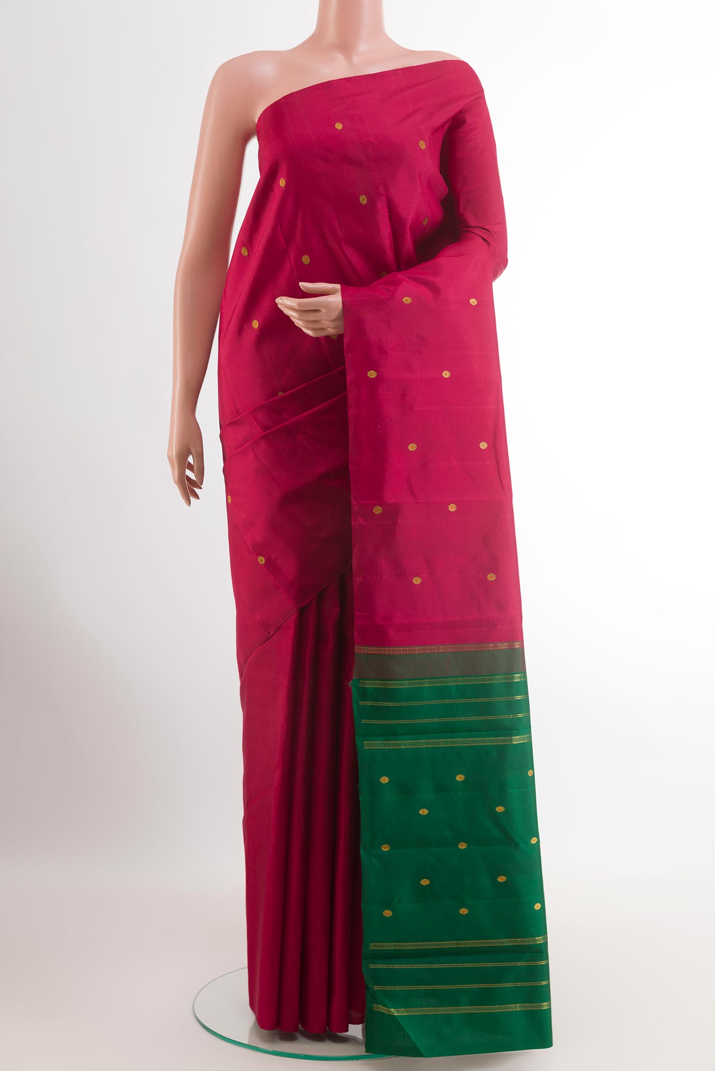 Maroon Kanchipuram Silk Saree with Zari Butta on the body and Ganga Jamuna Border.  displayed on a mannequin