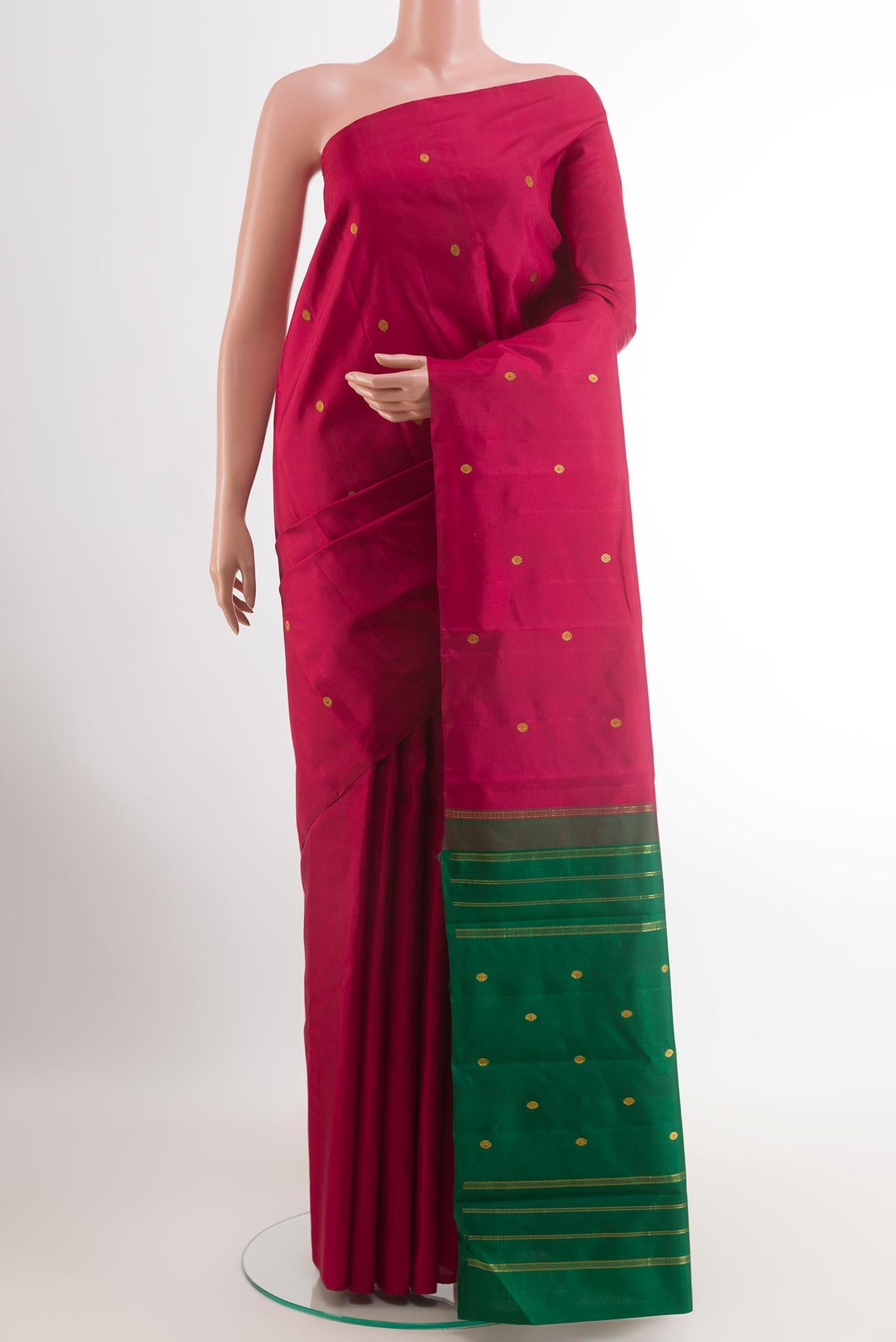 Maroon Kanchipuram Silk Saree with Zari Butta on the body and Ganga Jamuna Border.  displayed on a mannequin