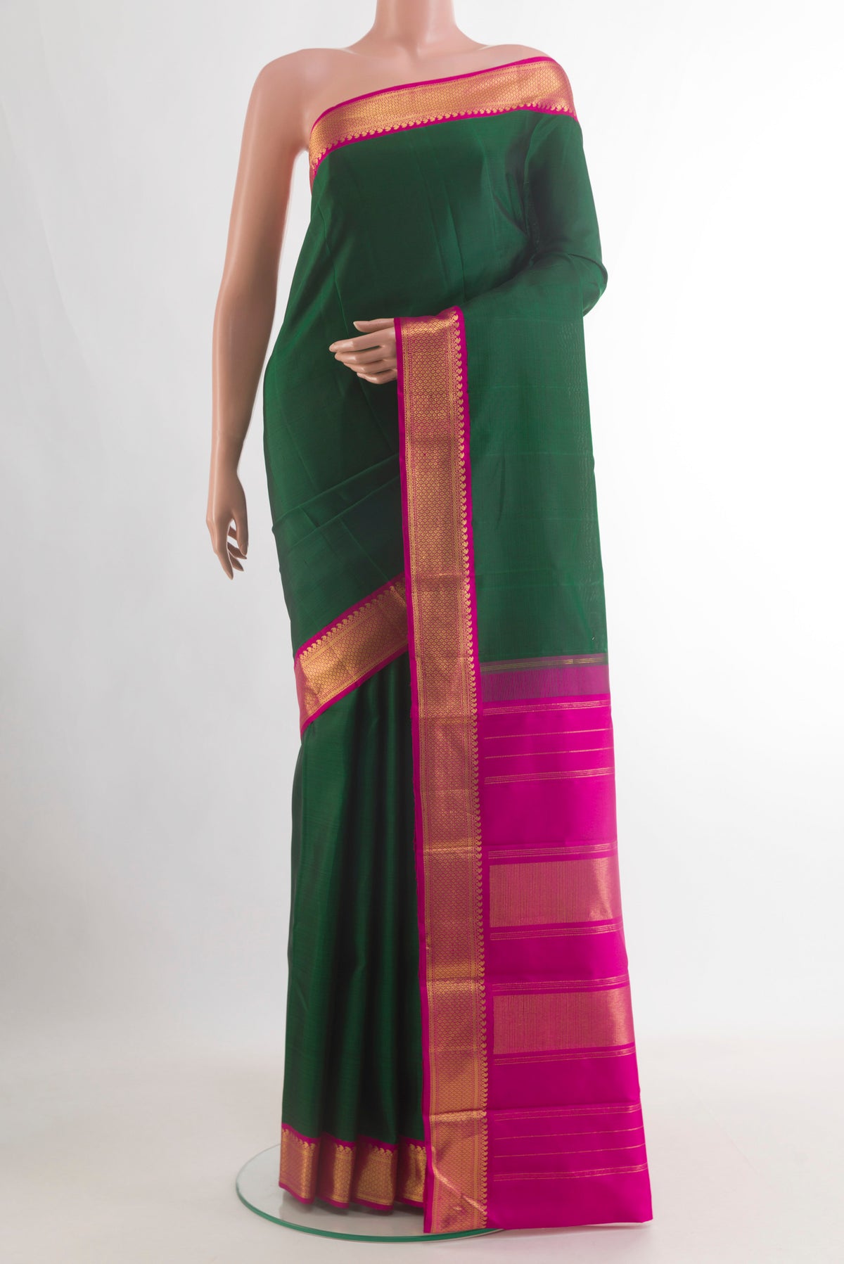 Pure Silk Bottle Green Kanjivaram Saree with Plain Body and Zari Border.  displayed on a mannequin