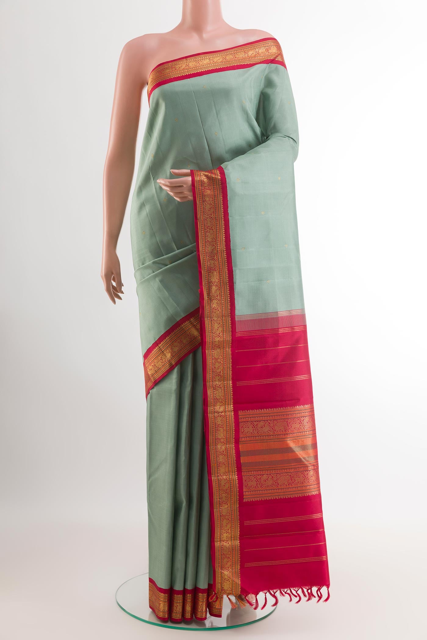 Grey Kanchipuram Silk Saree with Zari Butta on the body and Zari Border.  displayed on a mannequin