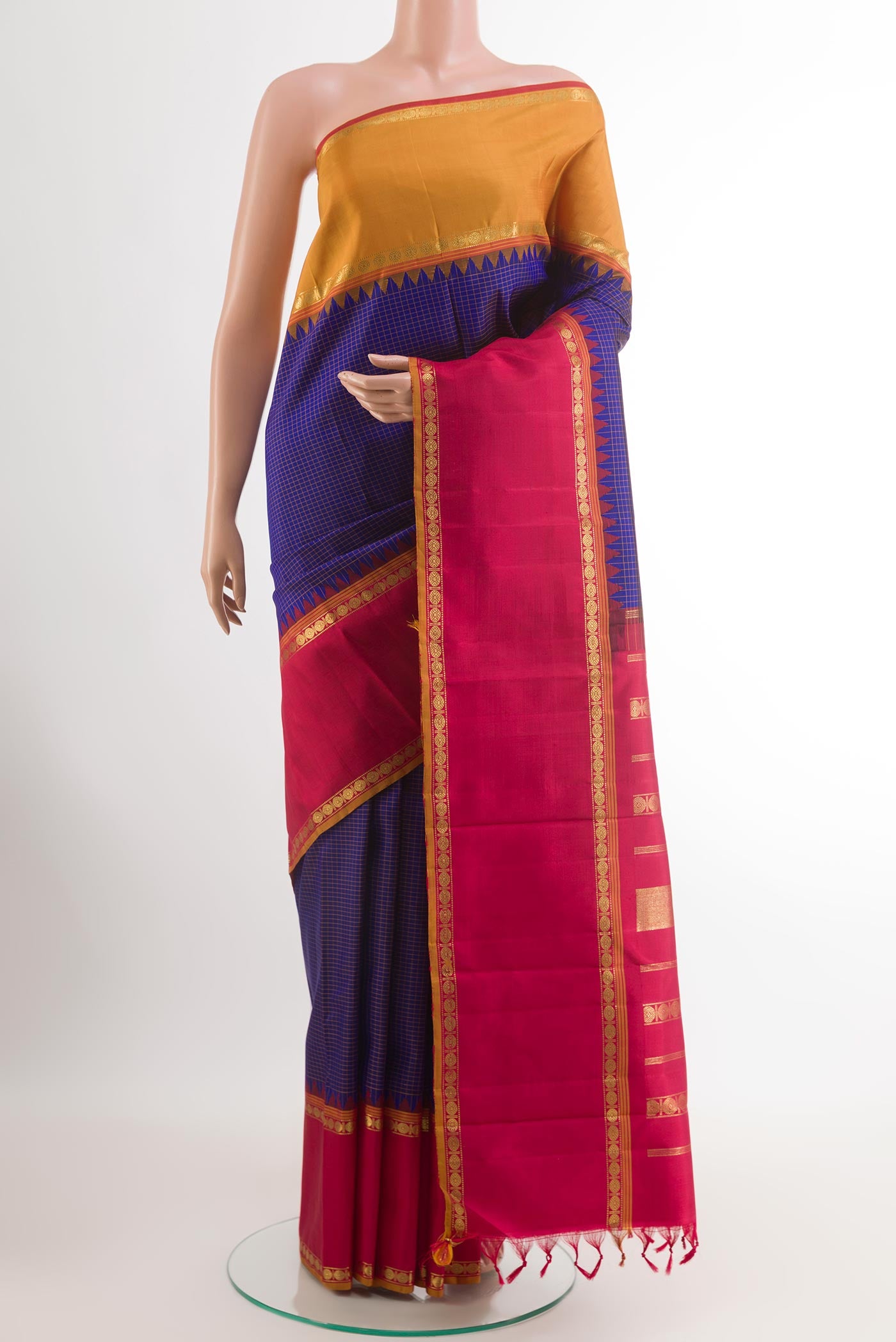 Blue Kanchipuram Silk Saree with Checked design on the body and Ganga Jamuna Border.  displayed on a mannequin