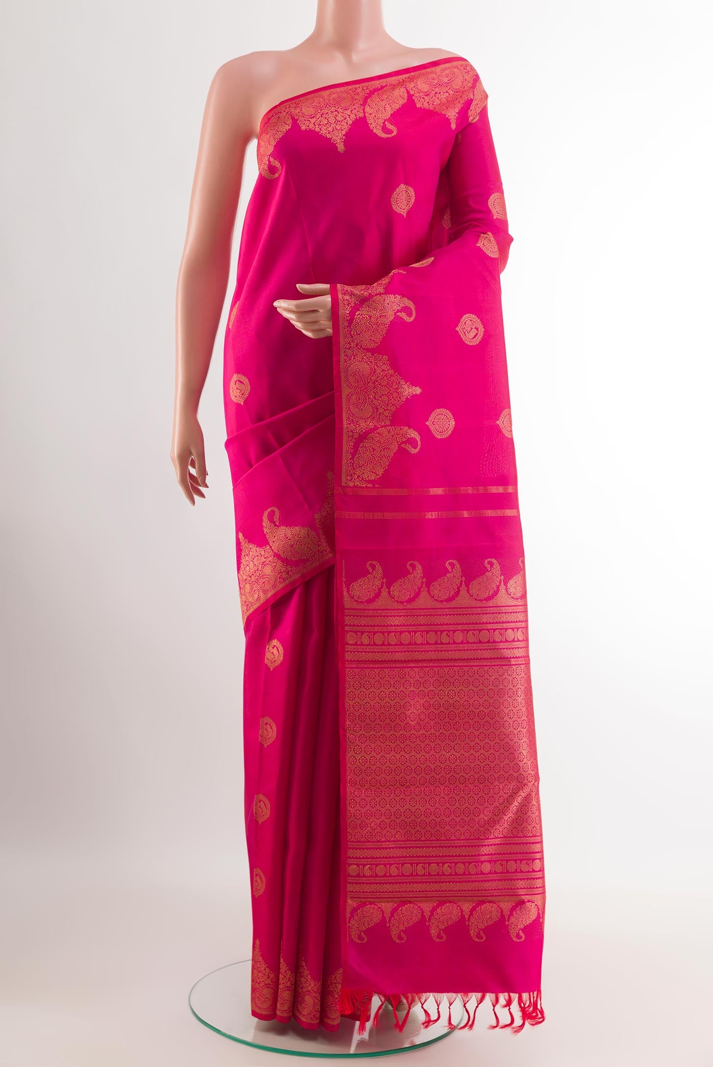 Pink Kanchipuram Silk Saree with Zari Butta on the body and Zari Border.  displayed on a mannequin