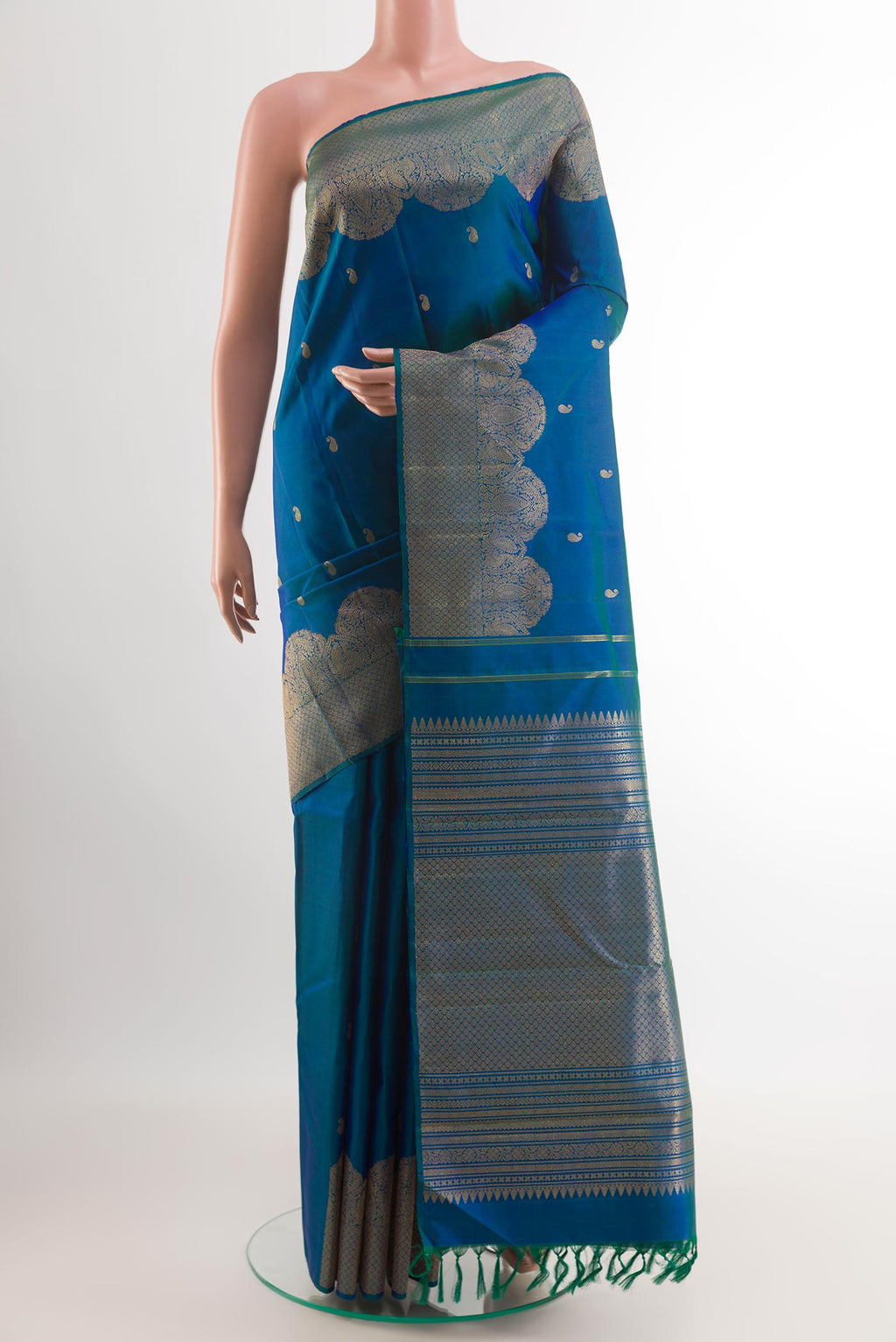 Peacock Blue Kanchipuram Silk Saree with Zari Butta on the body and Zari Border.  displayed on a mannequin