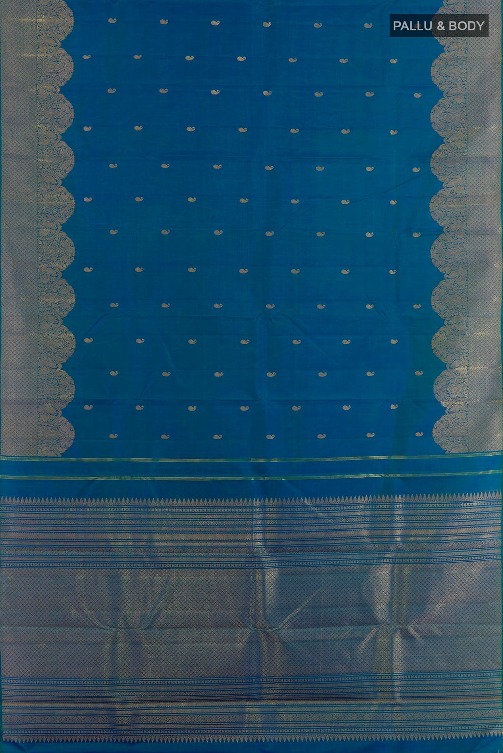 Flat view of Peacock Blue Kanchipuram Silk Saree with Zari Butta on the body and Zari Border. 