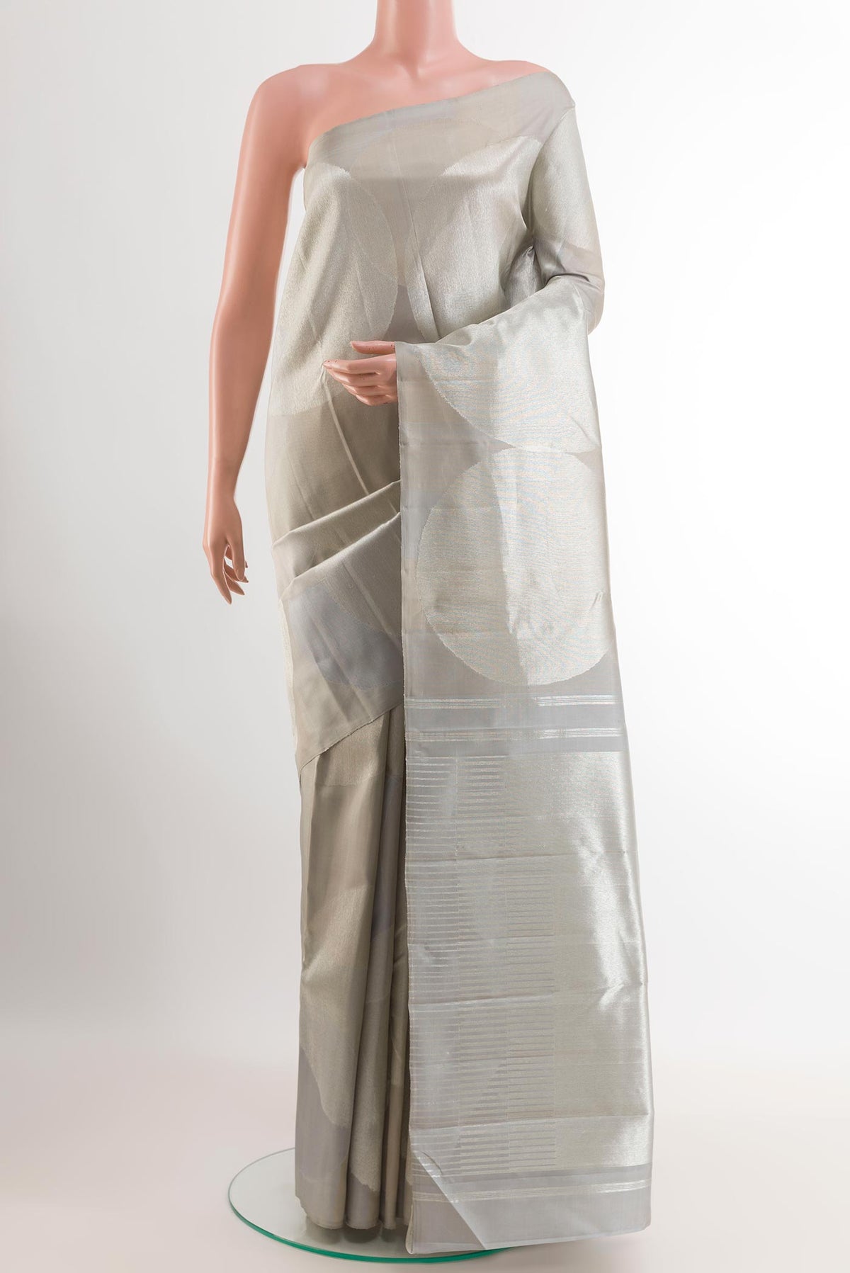 Silver Kanjivaram Silk Saree with Zari Brocade on the body and Zari Border.  displayed on a mannequin