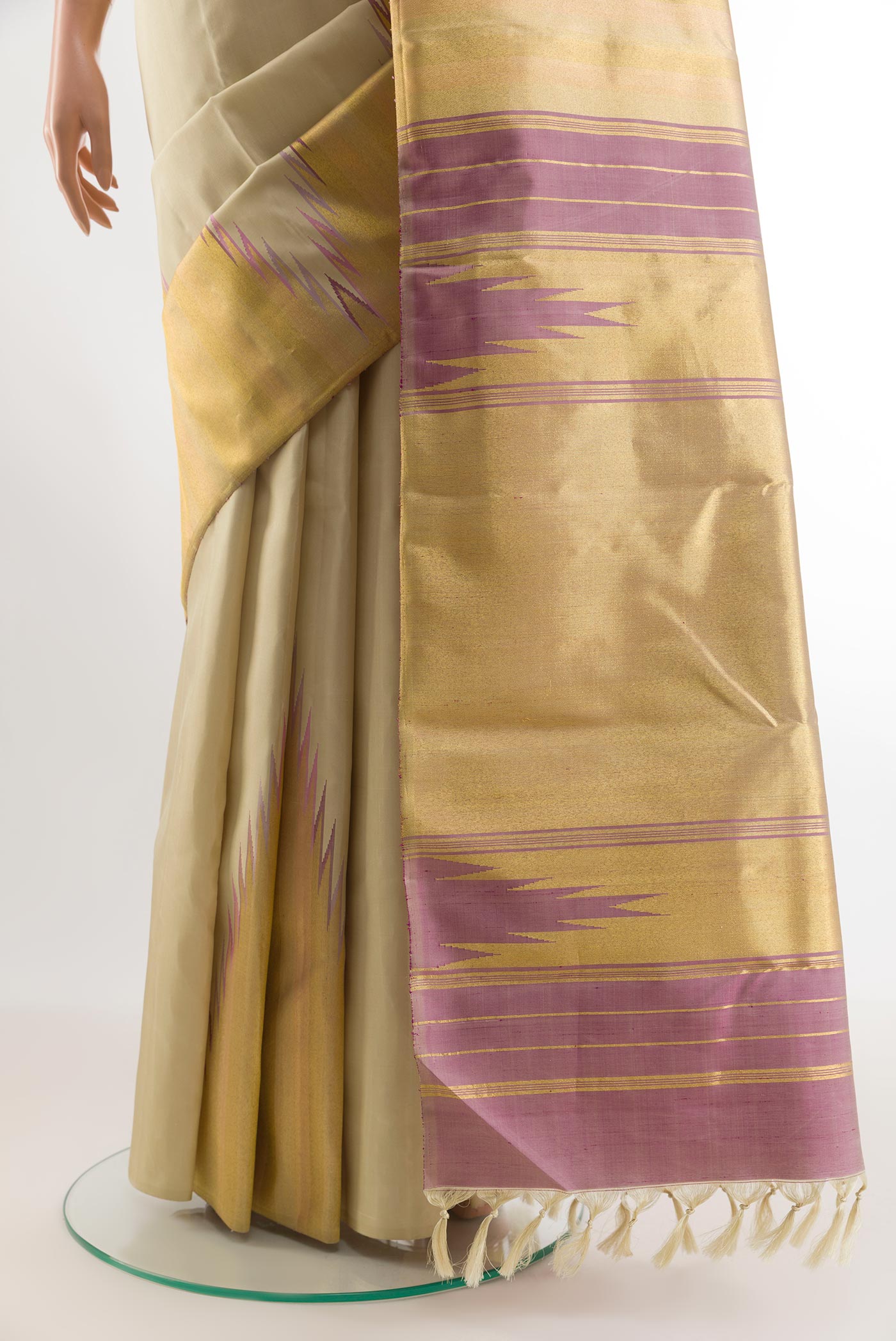 Pleats and pallu of Cream Kanchipuram Silk Saree with Plain Body and Rising Temple Border. 