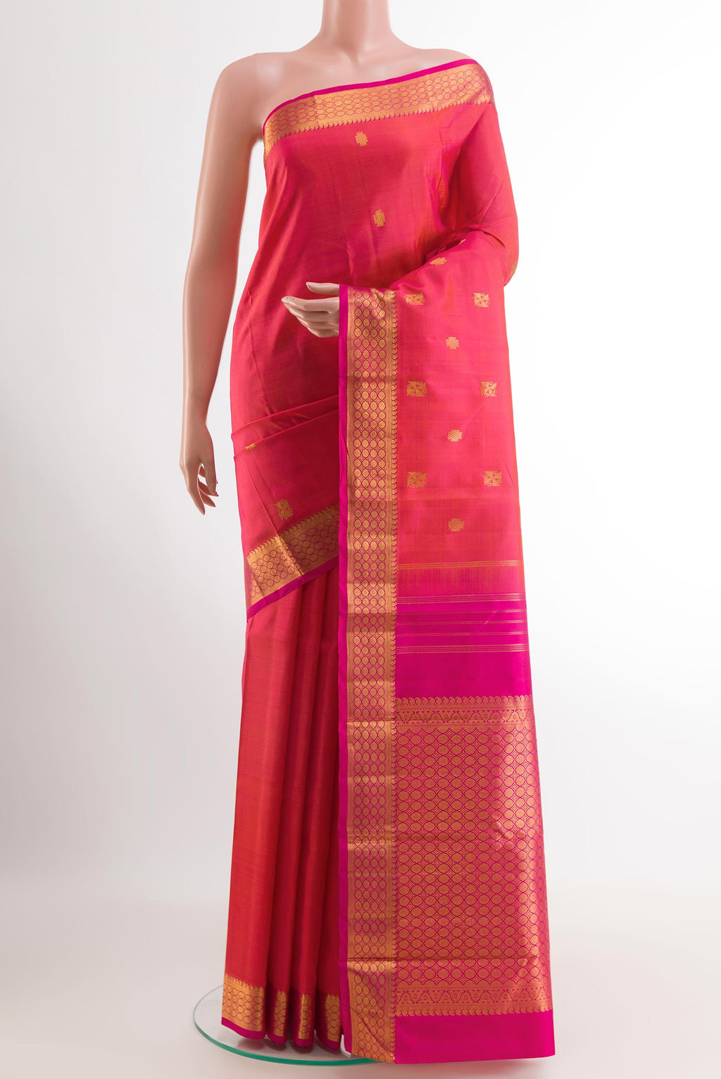 Pink Kanchipuram Silk Saree with Zari Butta on the body and Zari Border.  displayed on a mannequin