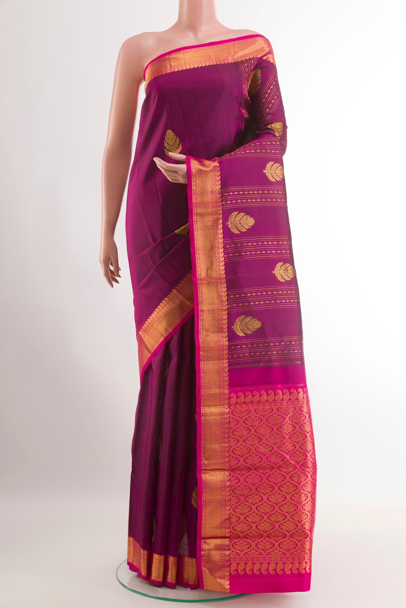 Purple Kanjivaram Silk Saree with Zari Butta on the body and Zari Border.  displayed on a mannequin