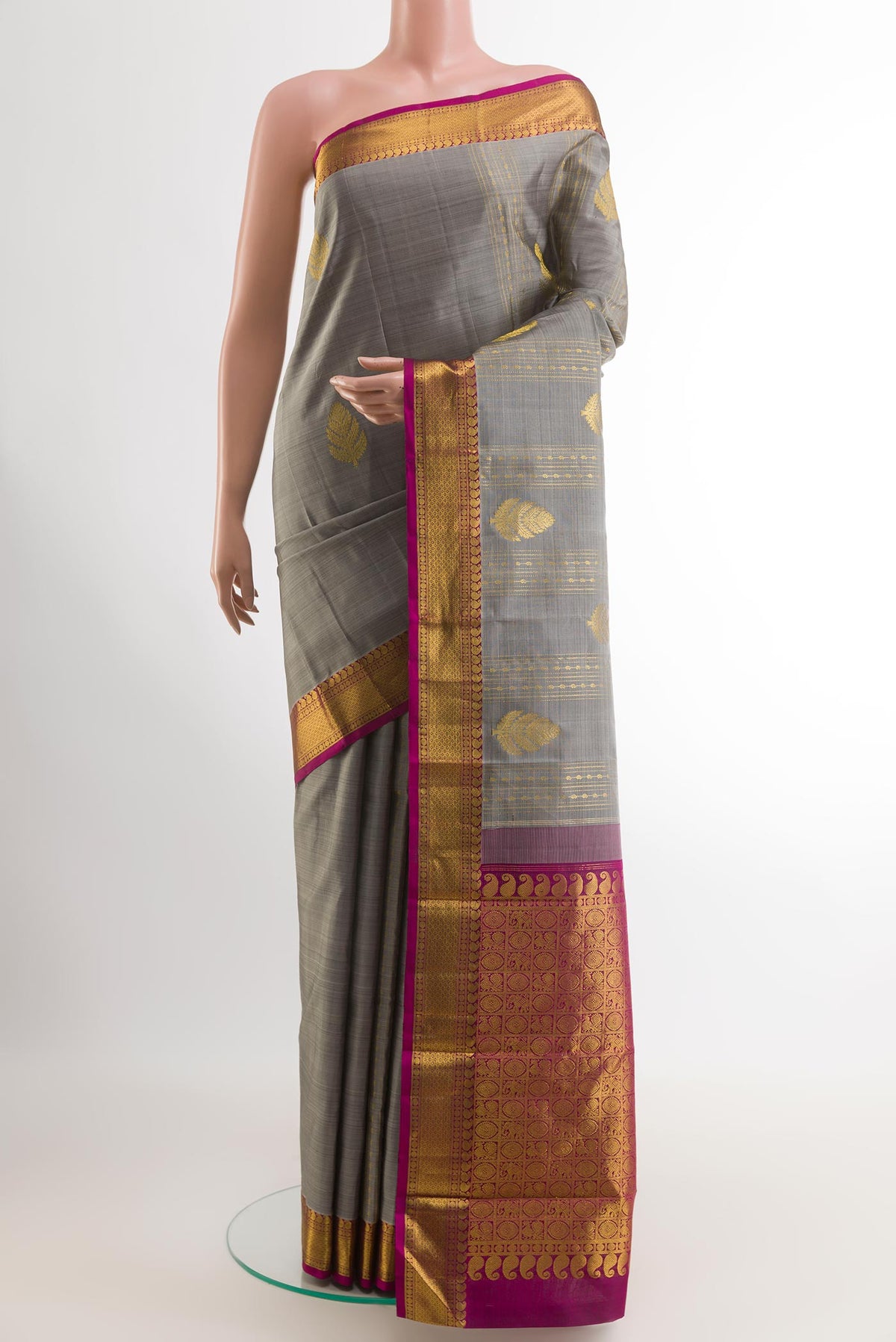 Grey Kanjivaram Silk Saree with Zari Butta on the body and Zari Border.  displayed on a mannequin