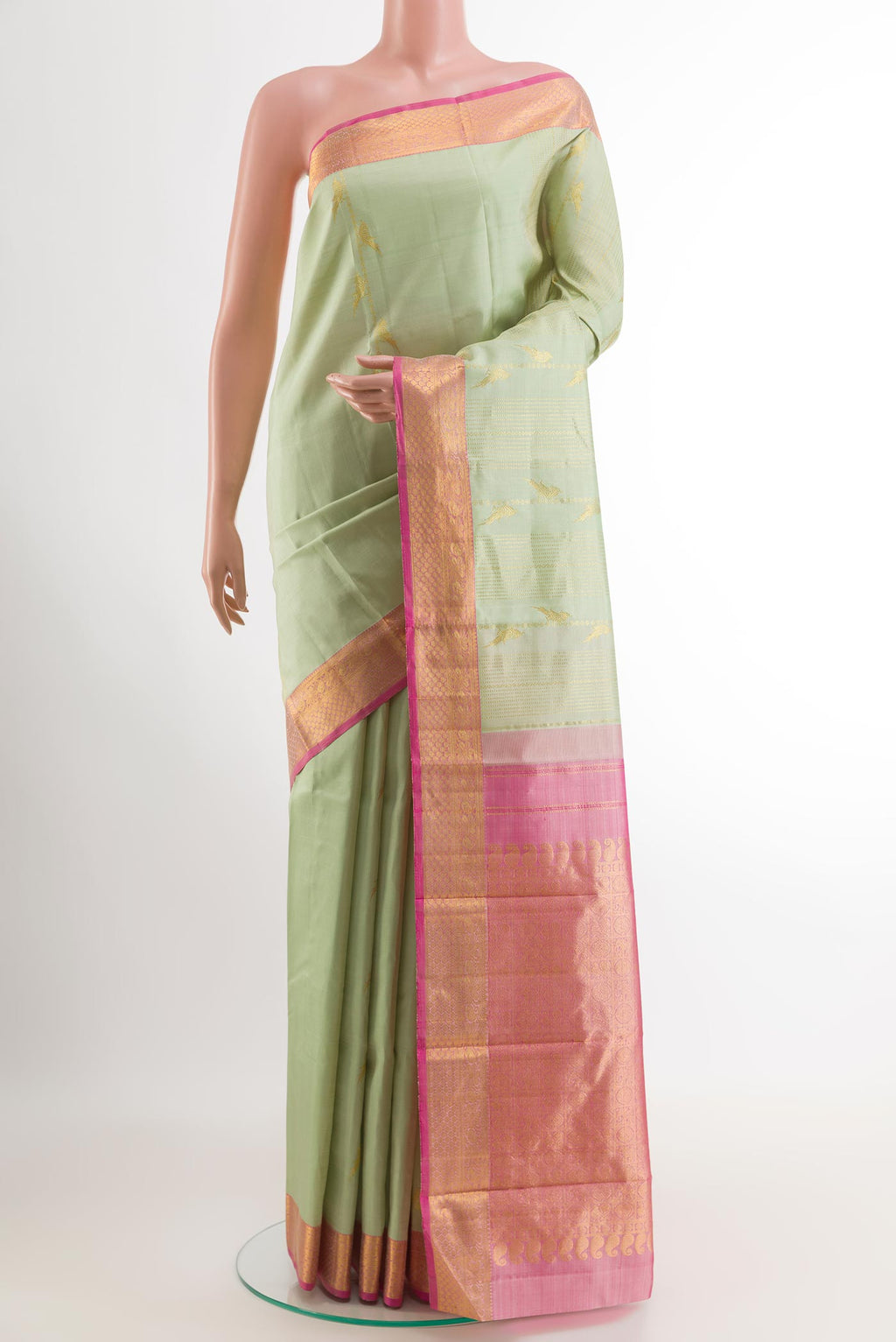 Mint Green Kanjivaram Silk Saree with Zari Butta on the body and Zari Border.  displayed on a mannequin