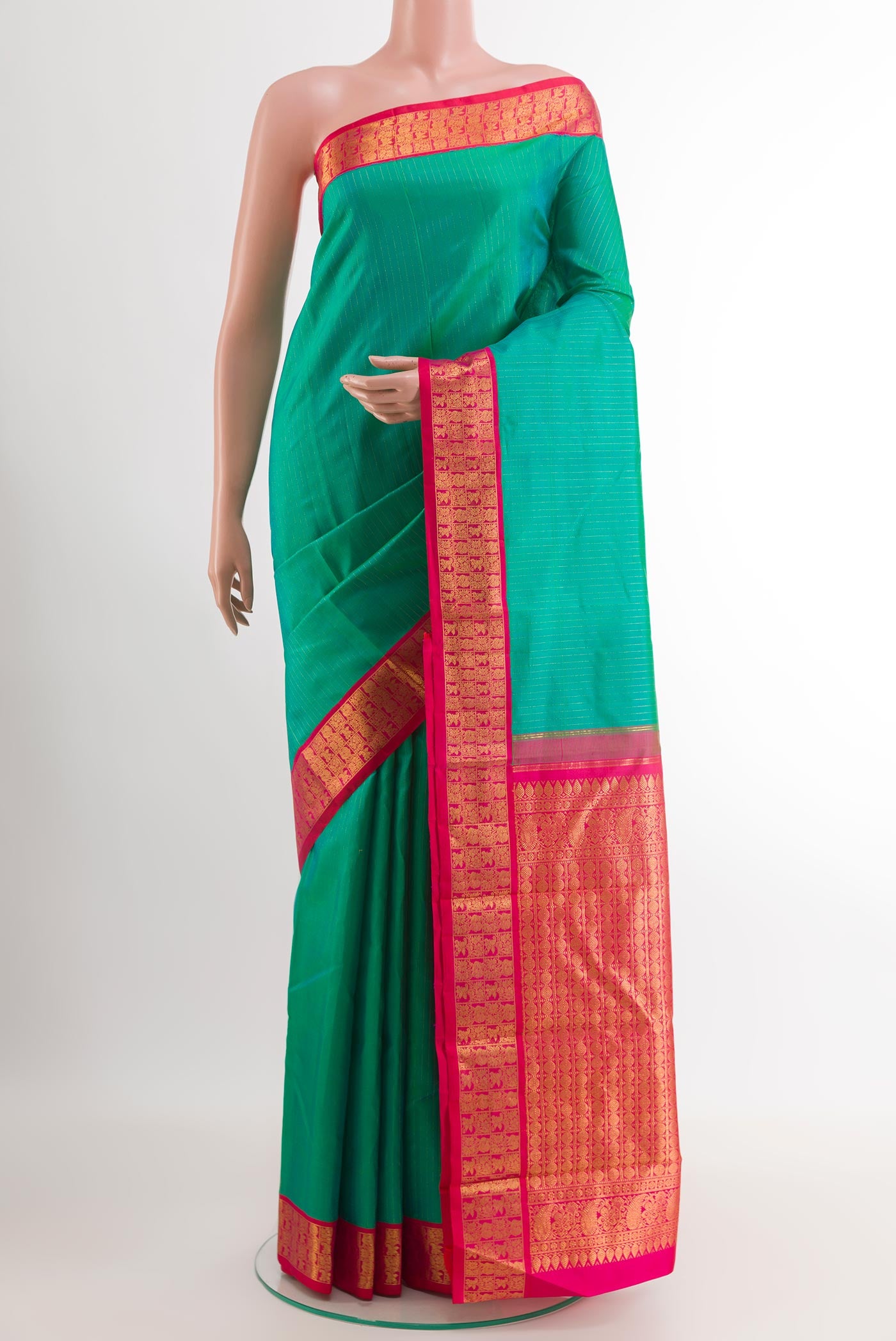 Green Kanjivaram Silk Saree with Stripes on the body and Zari Border.  displayed on a mannequin