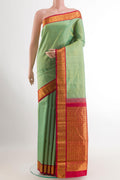 Mint Green Kanjivaram Silk Saree with Zari Butta on the body and Zari Border.  displayed on a mannequin