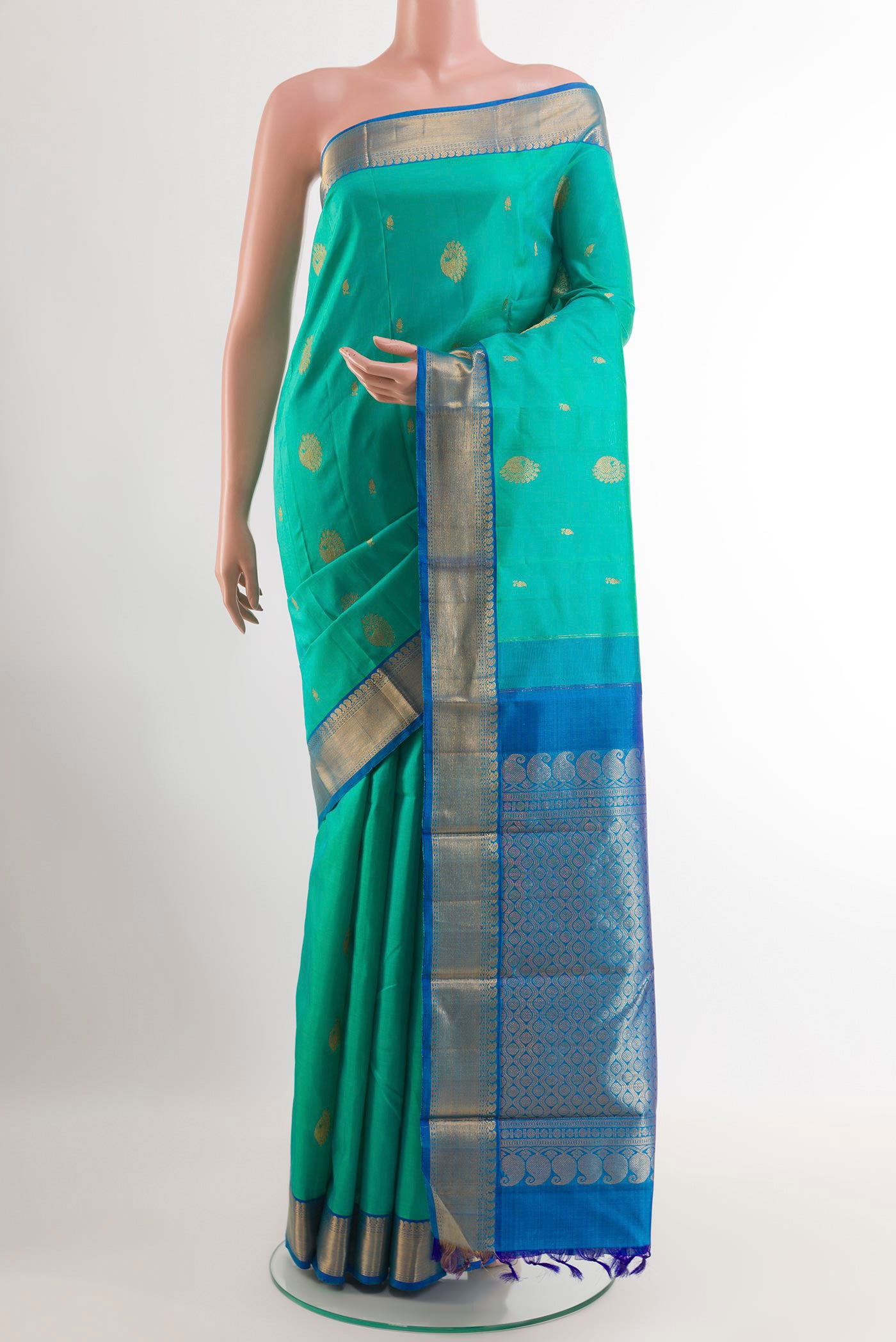Sea Green Kanjivaram Silk Saree with Zari Butta on the body and Zari Border.  displayed on a mannequin