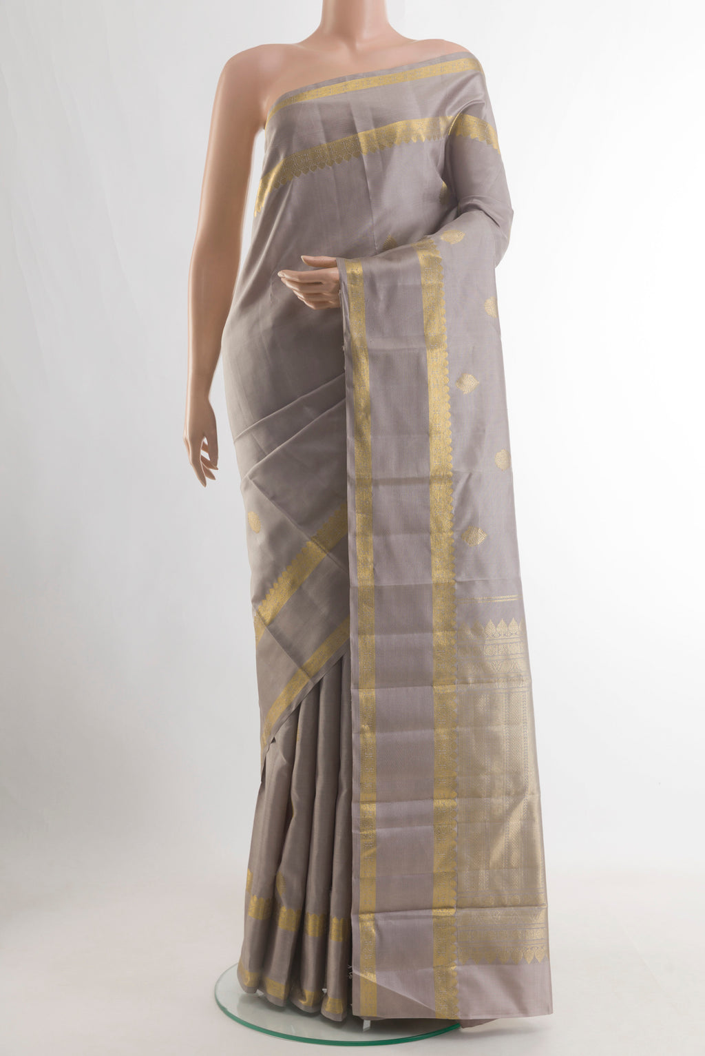 Grey Kanjivaram Silk Saree with Zari Butta on the body and Zari Border.  displayed on a mannequin
