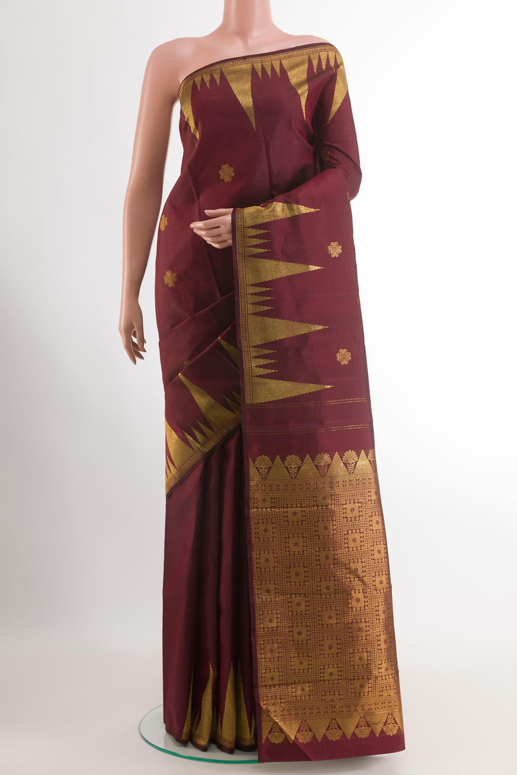 Maroon Kanjivaram Silk Saree with Zari Butta on the body and Zari Border.  displayed on a mannequin