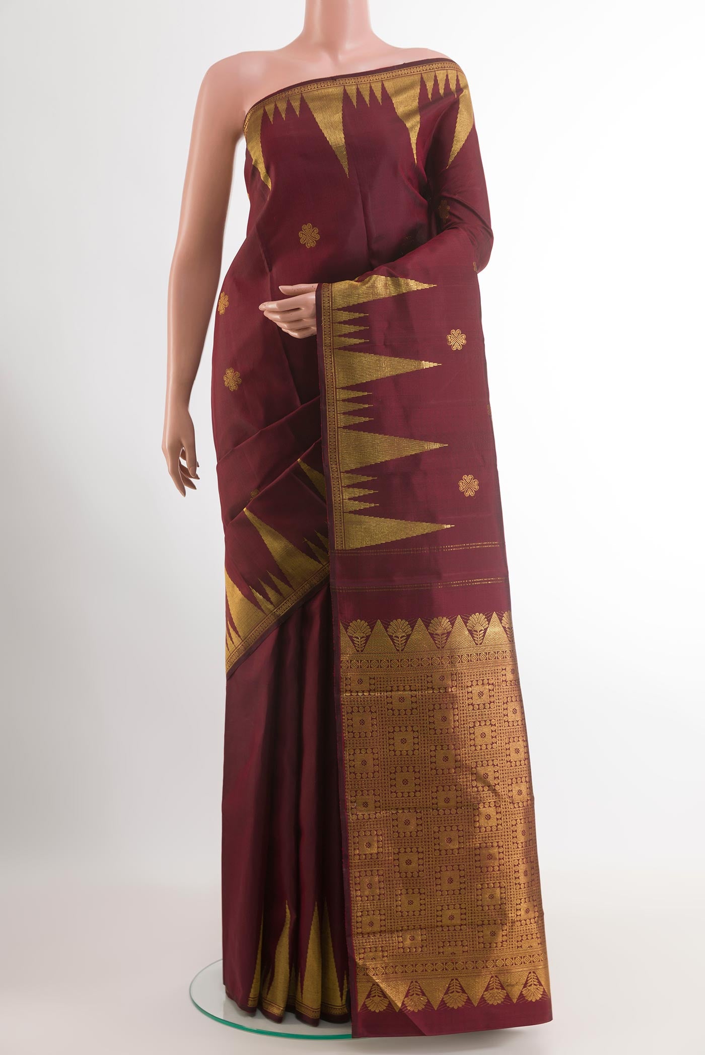 Maroon Kanjivaram Silk Saree with Zari Butta on the body and Zari Border.  displayed on a mannequin