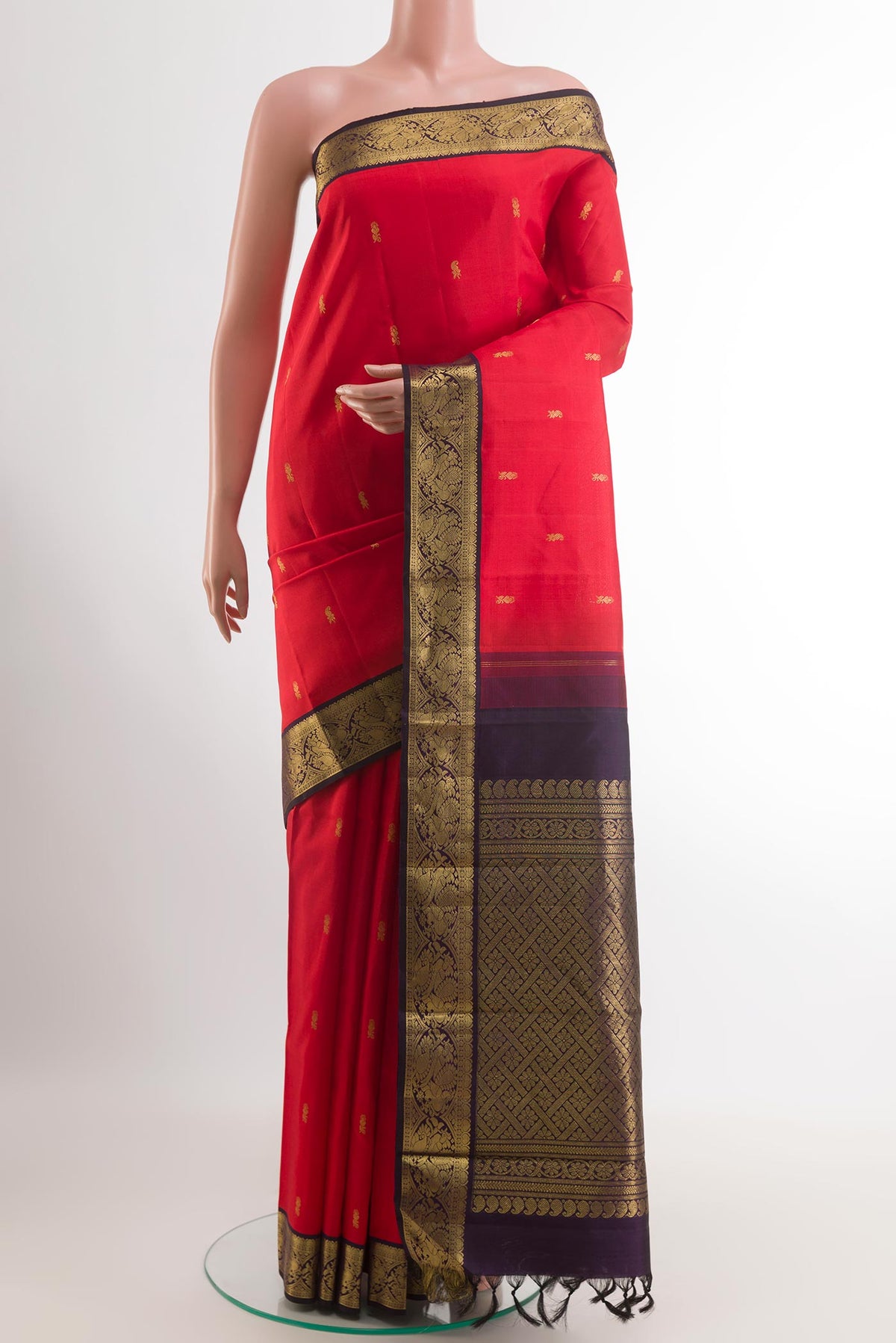 Red Kanjivaram Silk Saree with Zari Butta on the body and Zari Border.  displayed on a mannequin