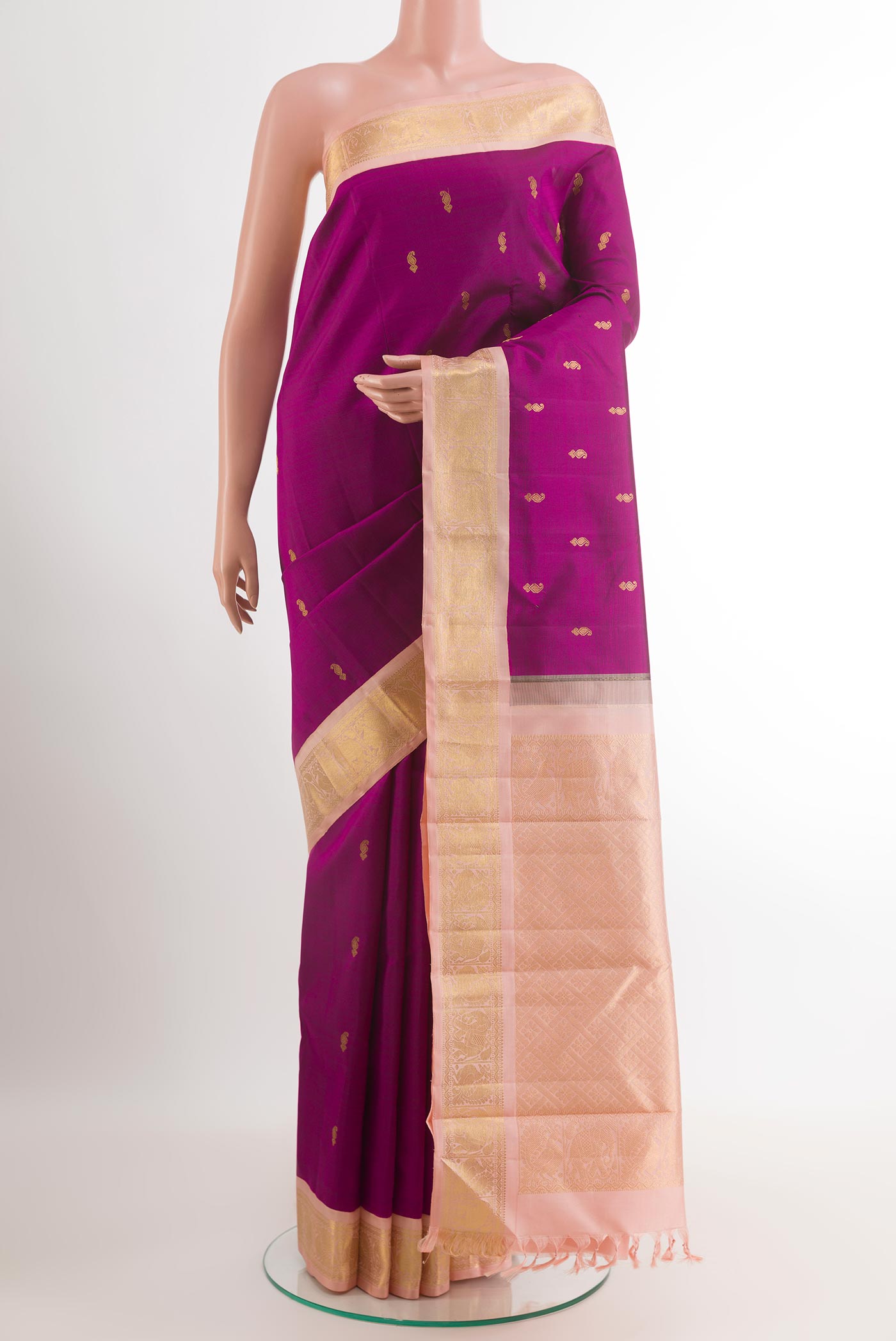 Purple Kanjivaram Silk Saree with Zari Butta on the body and Zari Border.  displayed on a mannequin