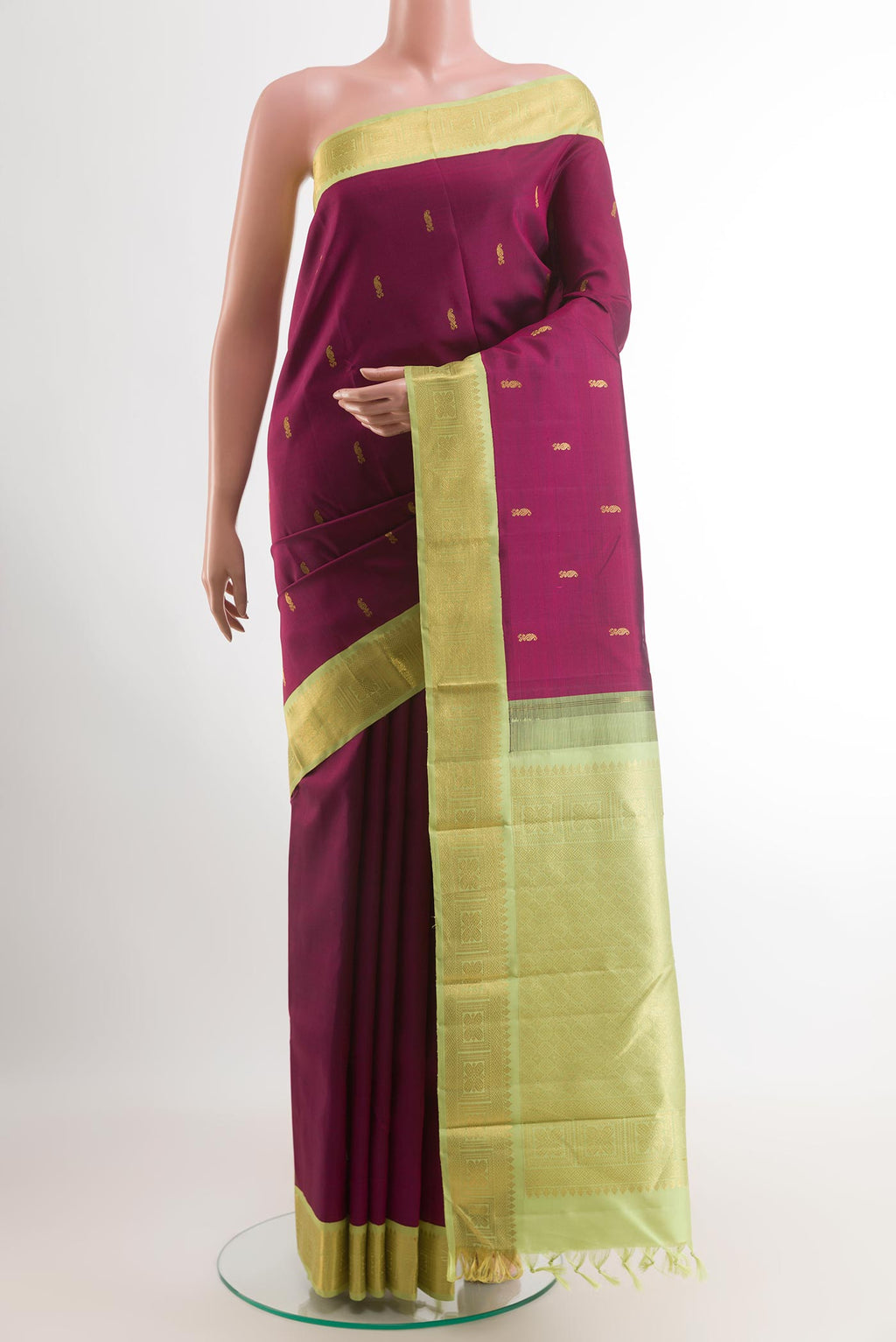 Purple Kanjivaram Silk Saree with Zari Butta on the body and Zari Border.  displayed on a mannequin