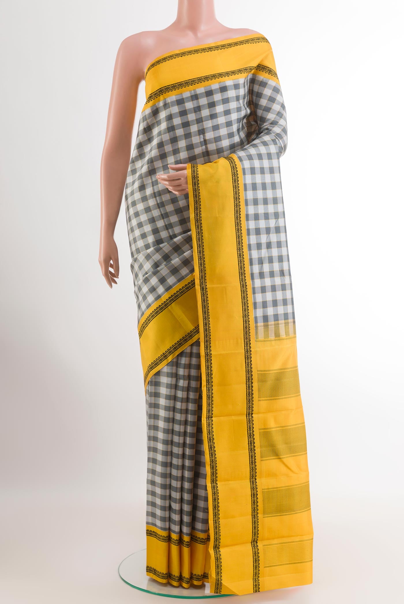 Off White Kanjivaram Silk Saree with Checked design on the body and Thread Border.  displayed on a mannequin