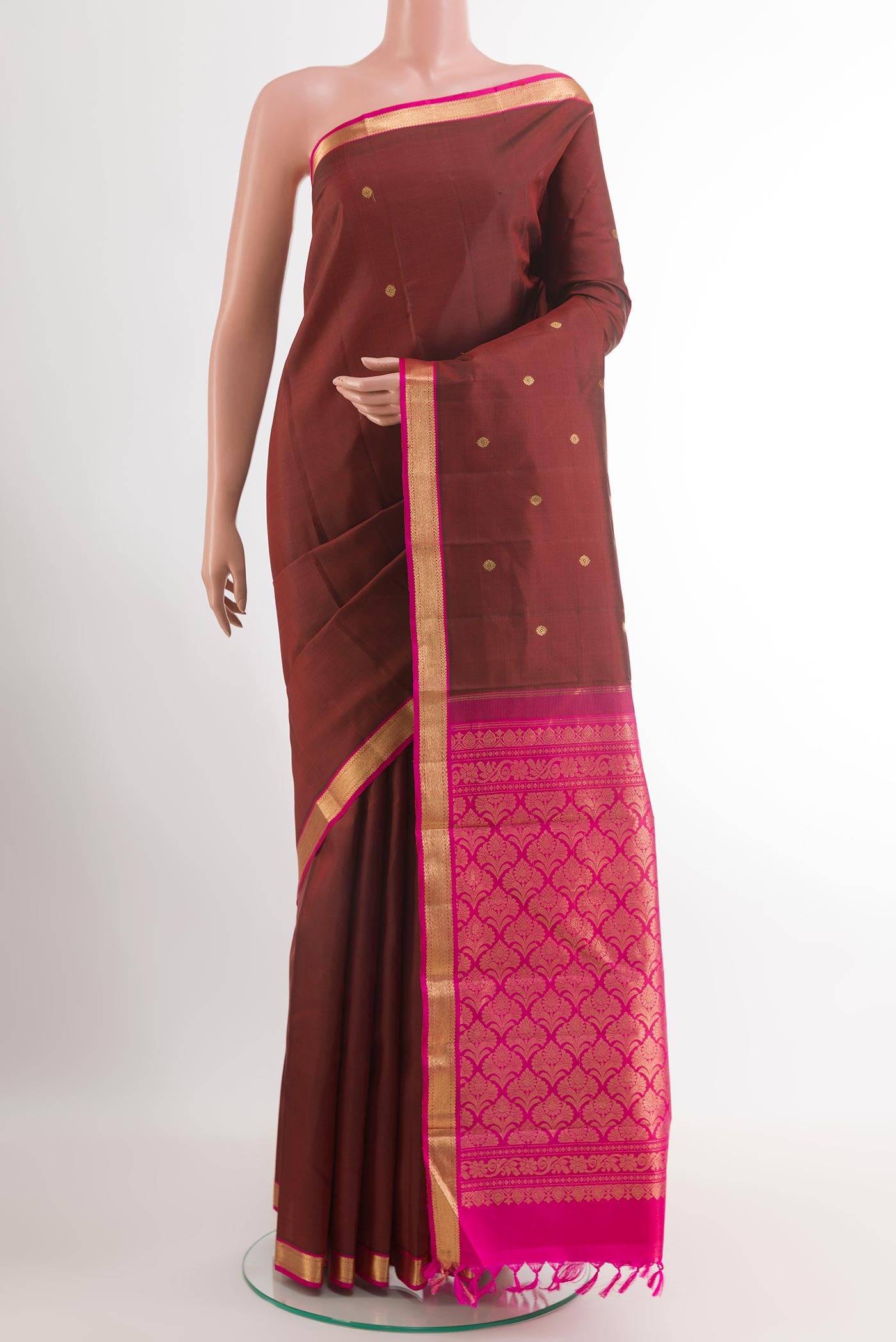 Maroon Kanchipuram Silk Saree with Zari Butta on the body and Zari Border.  displayed on a mannequin