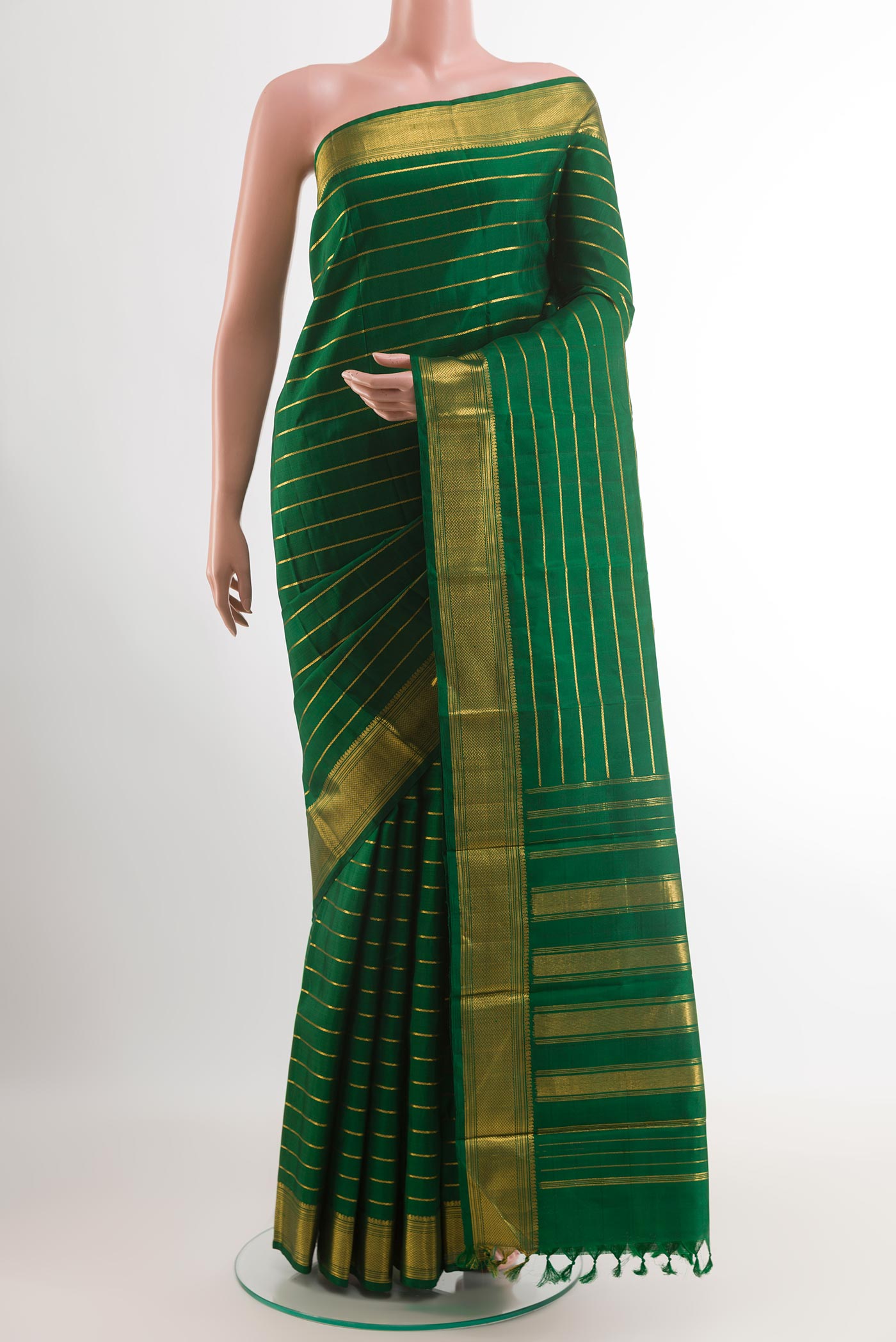 Green Kanchipuram Silk Saree with Stripes on the body and Zari Border.  displayed on a mannequin