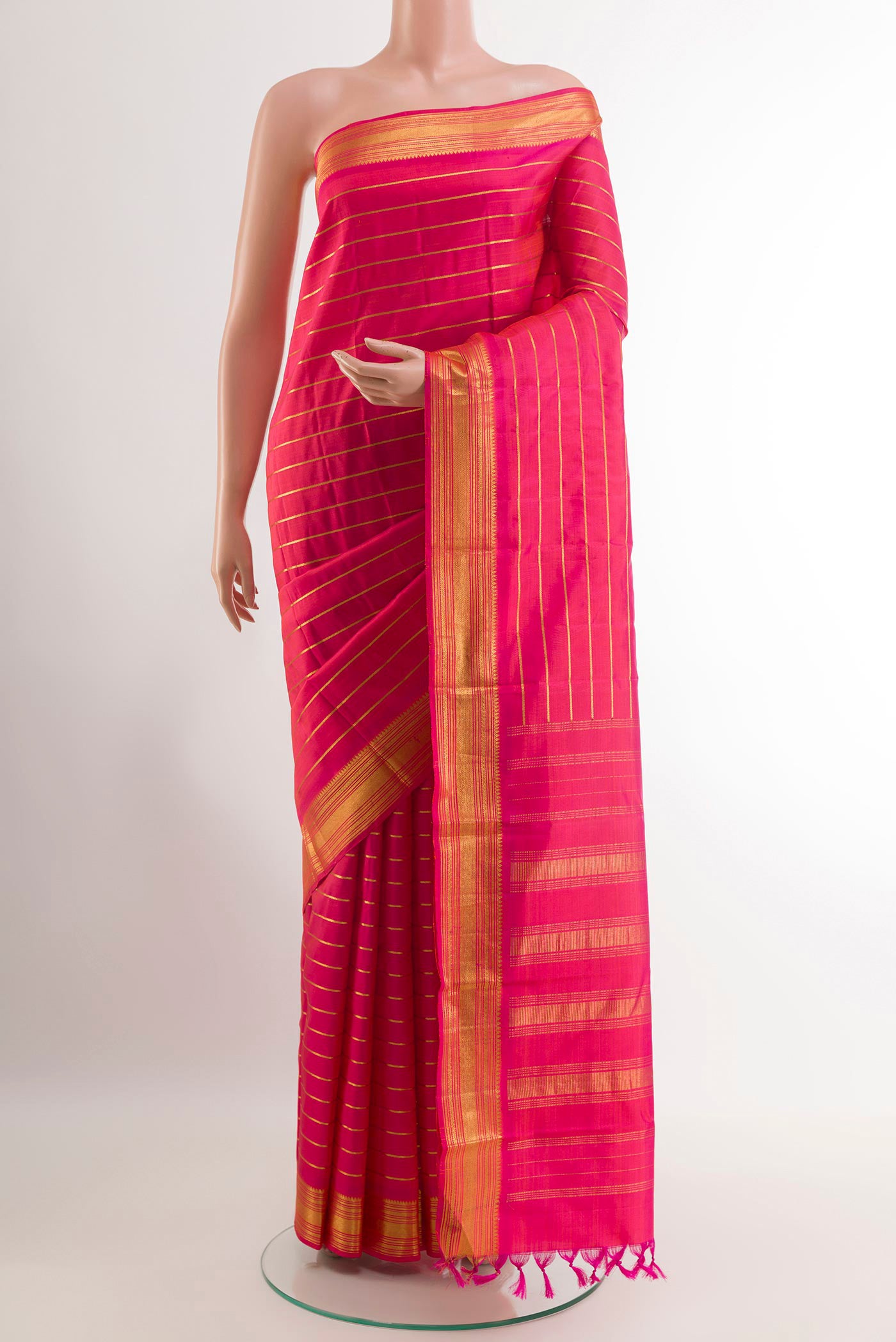 Pink Kanchipuram Silk Saree with Stripes on the body and Zari Border.  displayed on a mannequin