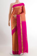Brick Orange Kanchipuram Silk Saree with Plain Body and Zari Border.  displayed on a mannequin