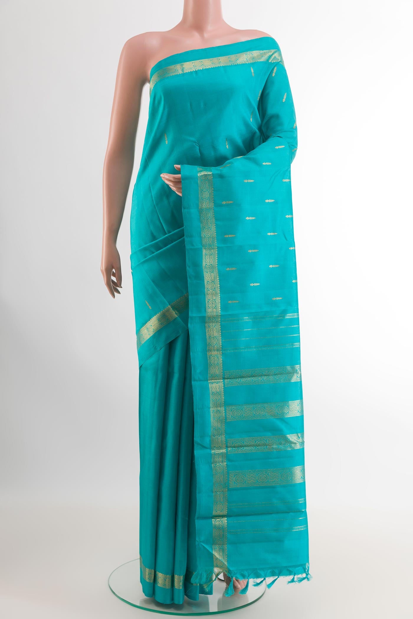 Blue Kanchipuram Silk Saree with Zari Butta on the body and Zari Border.  displayed on a mannequin