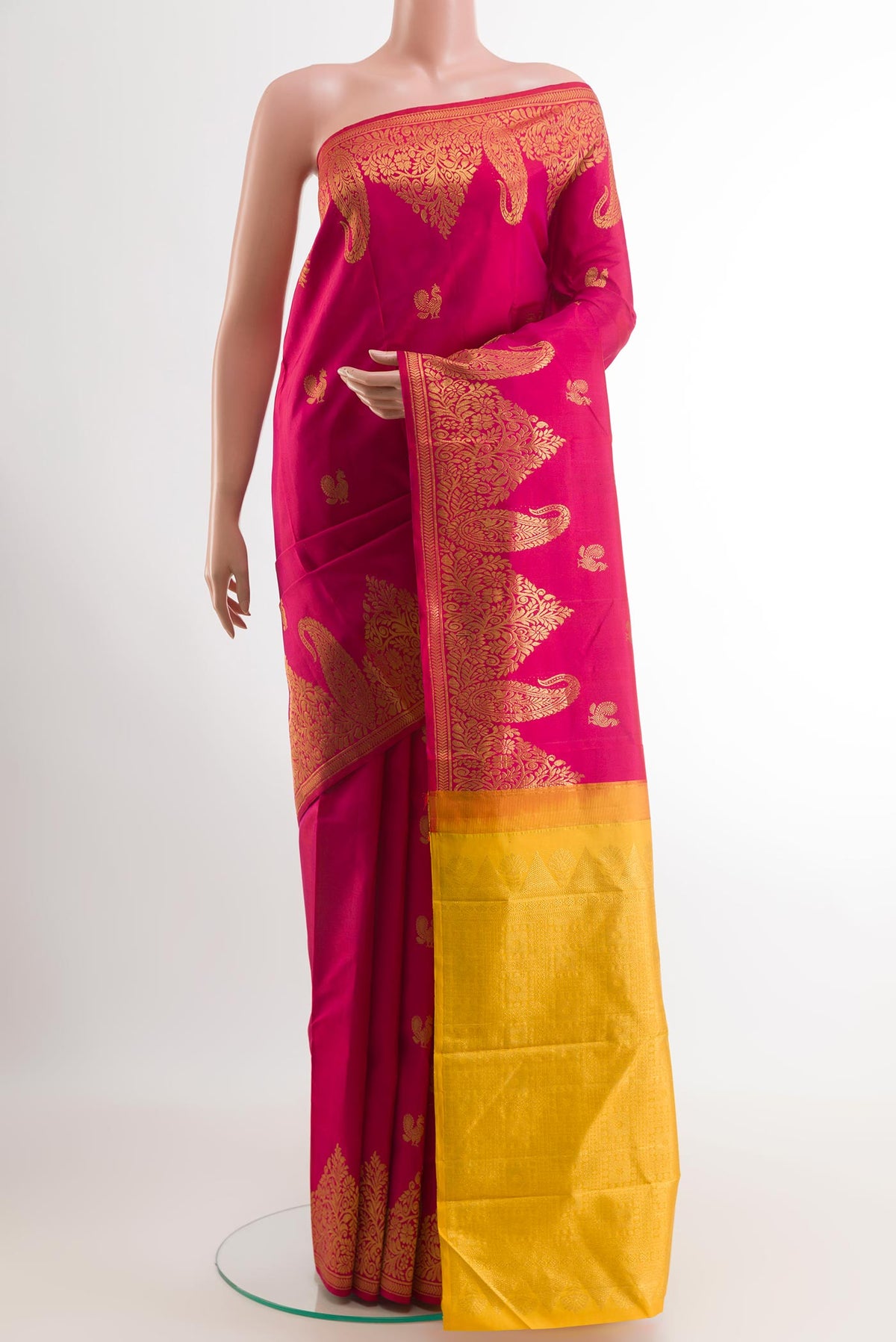 Pink Kanjivaram Silk Saree with Zari Butta on the body and Zari Border.  displayed on a mannequin