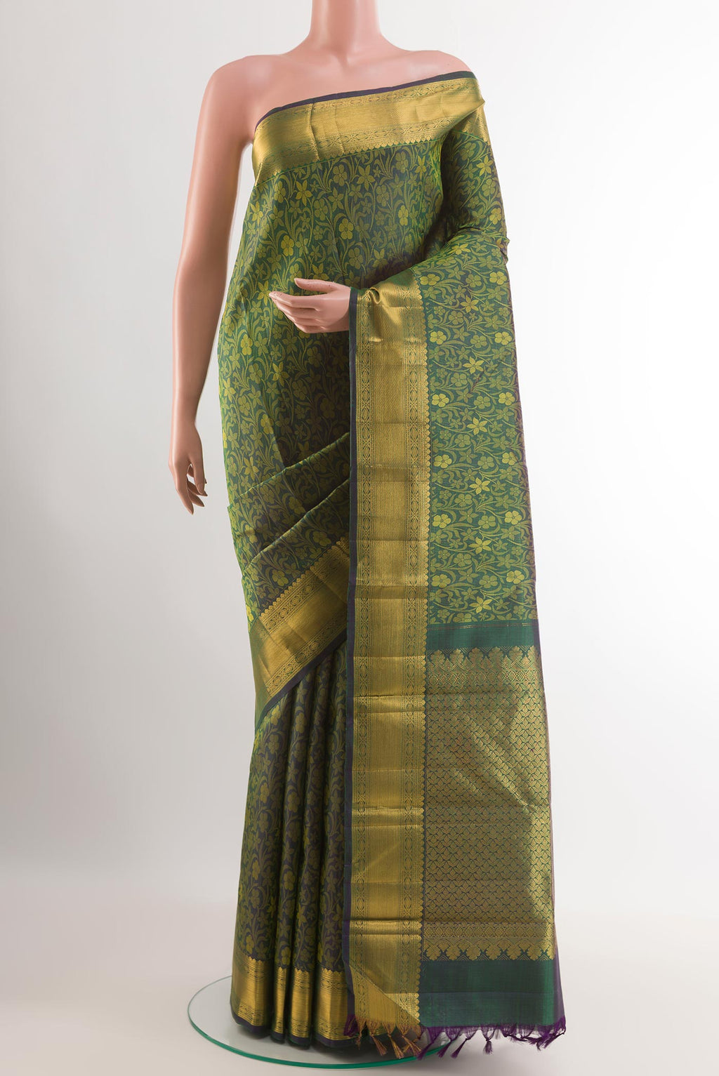 Green Kanjivaram Silk Saree with Jacquard design on the body and Zari Border.  displayed on a mannequin
